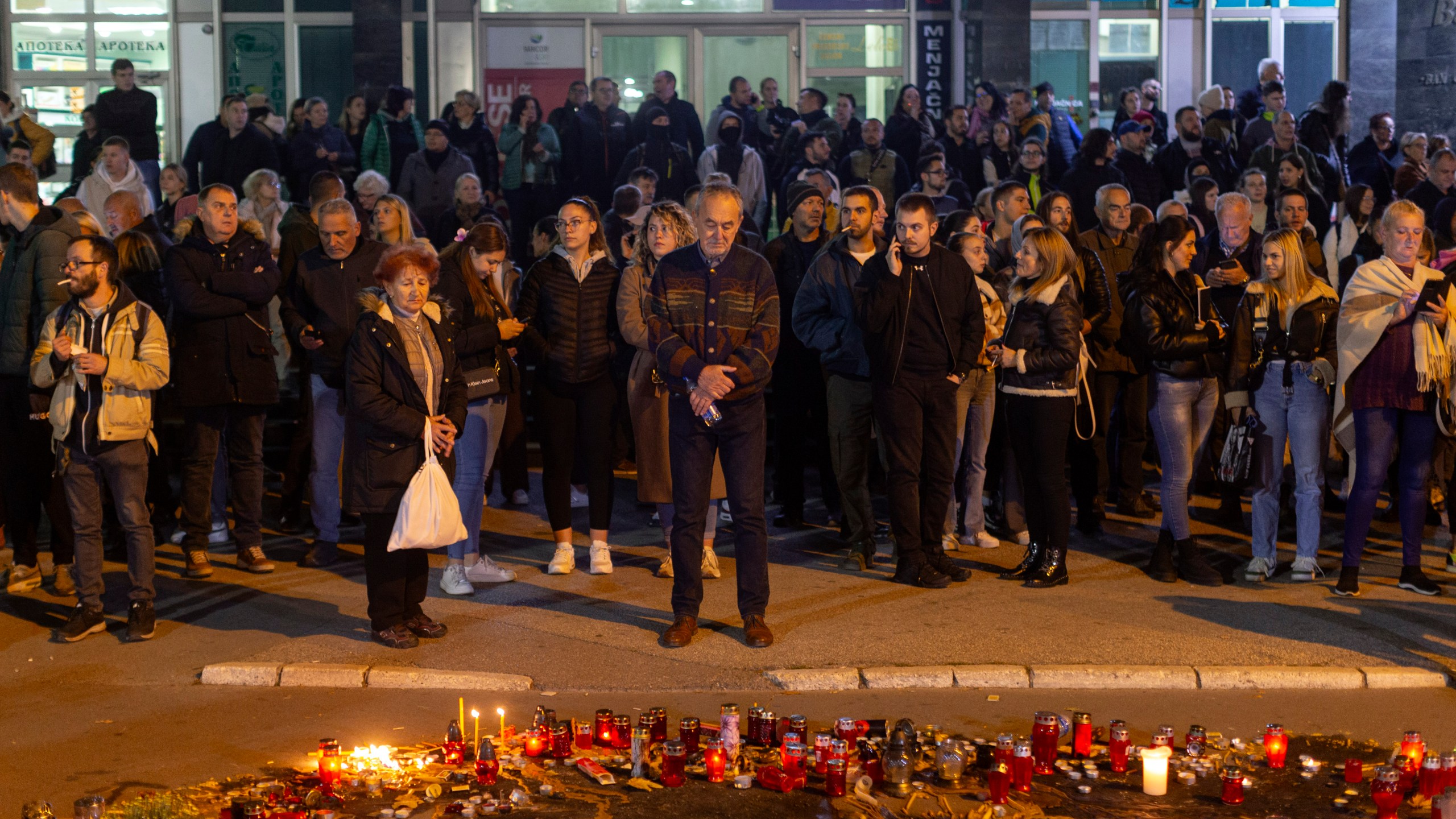 People pay respect to the 14 people killed at a local rail station during a protest in Novi Sad, Serbia, Tuesday, Nov. 5, 2024. (AP Photo/Marko Drobnjakovic)