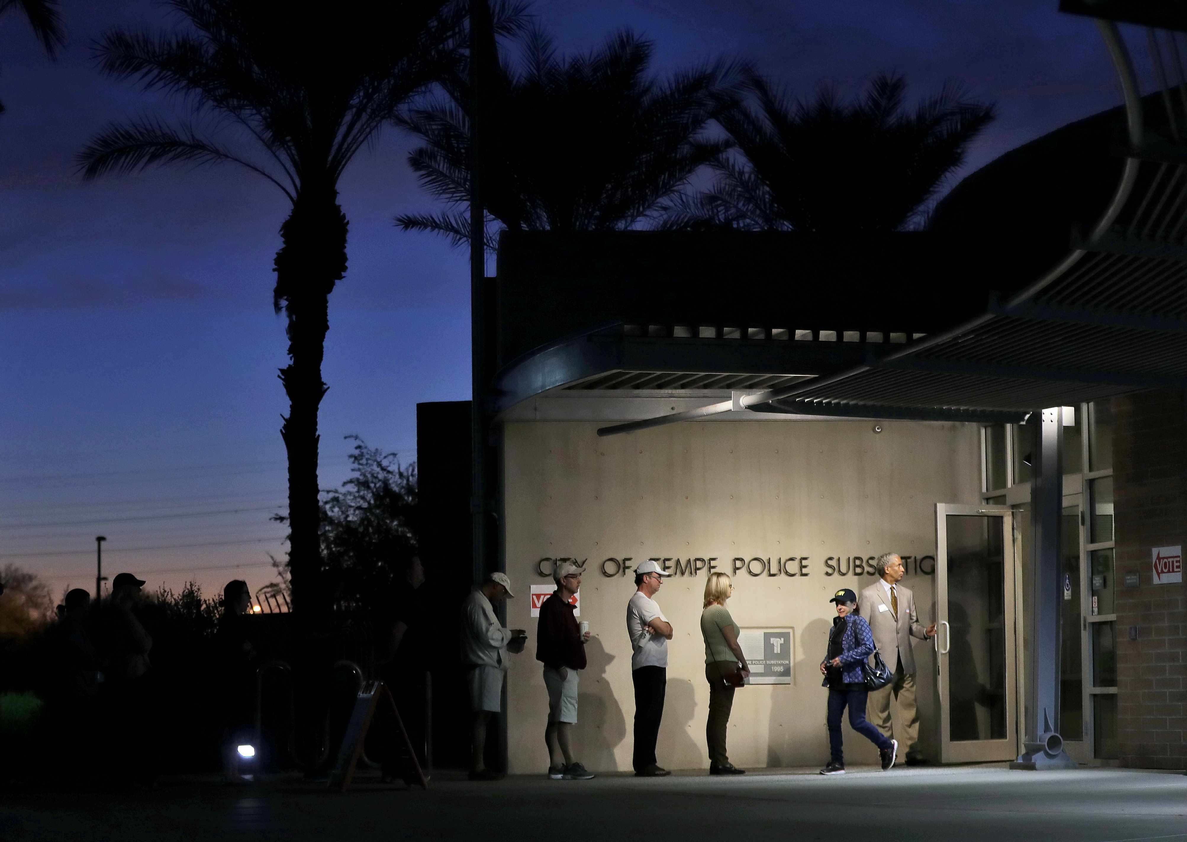 FILE - Voters wait in line to vote at their polling station early, Tuesday, Nov. 8, 2016, in Tempe, Ariz. (AP Photo/Matt York, File)