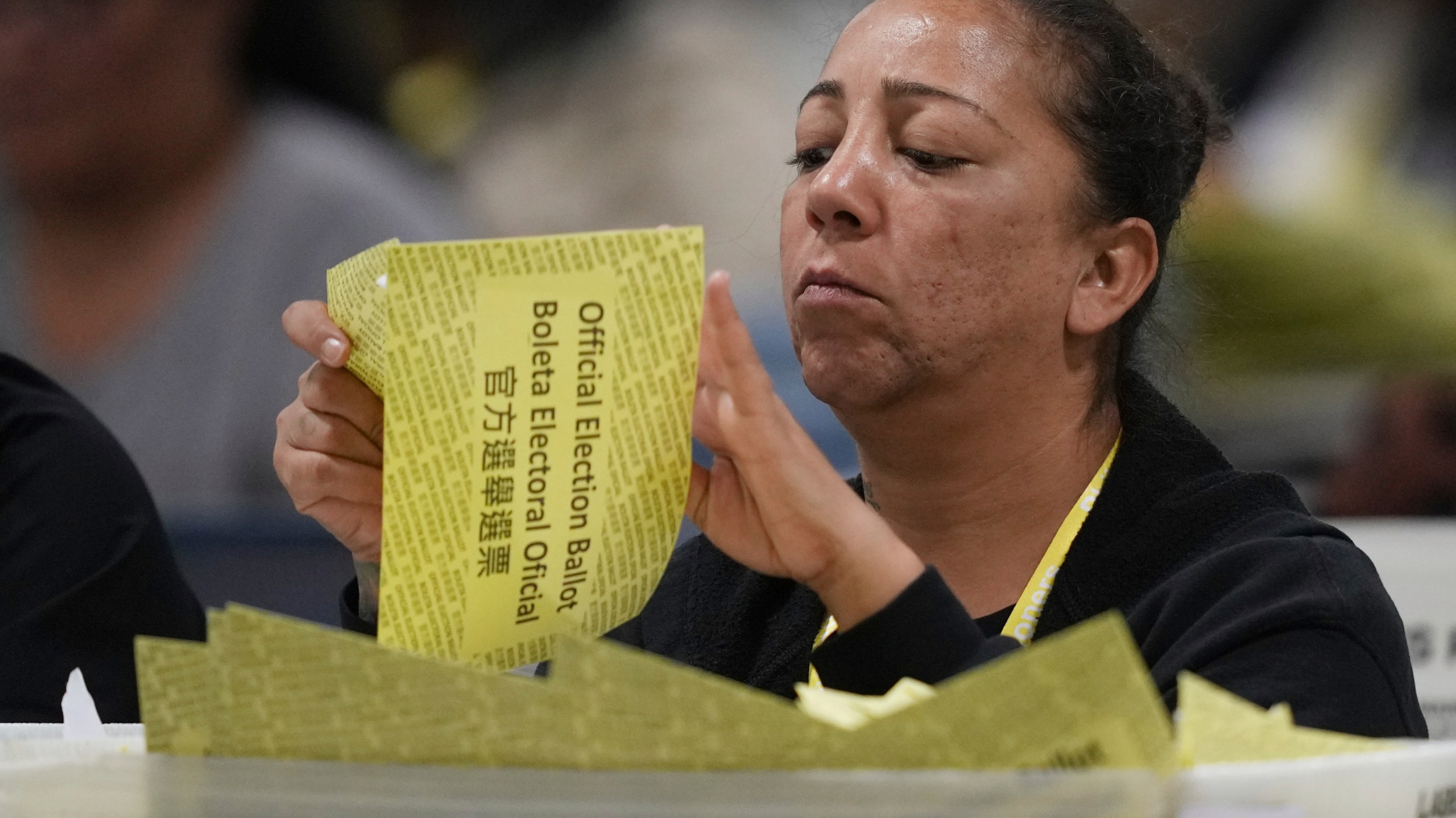 An election worker processes mail-in ballots for the 2024 General Election at the Philadelphia Election Warehouse, Tuesday, Nov. 5, 2024, in Philadelphia. (AP Photo/Matt Rourke)