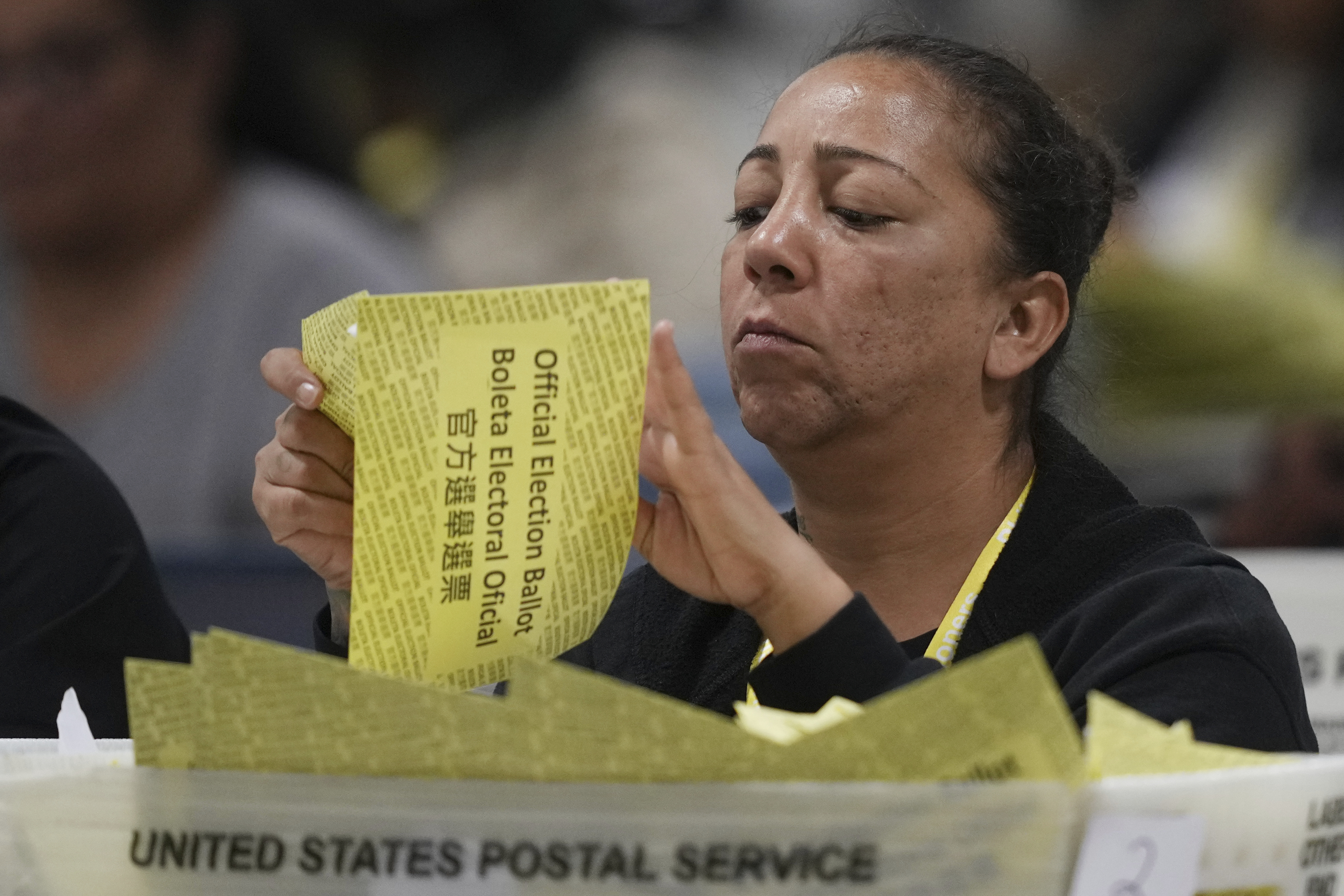 An election worker processes mail-in ballots for the 2024 General Election at the Philadelphia Election Warehouse, Tuesday, Nov. 5, 2024, in Philadelphia. (AP Photo/Matt Rourke)