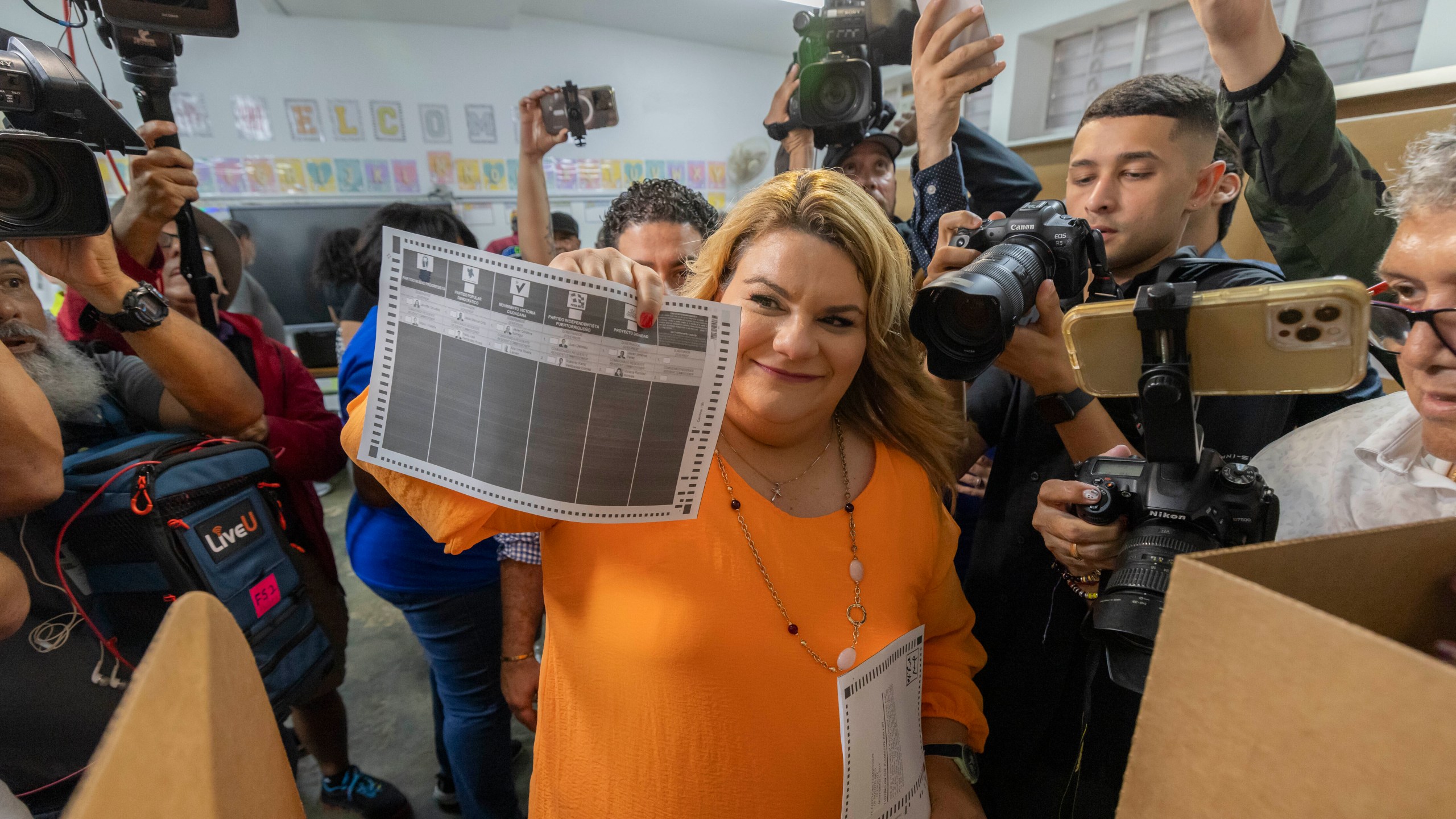 Jenniffer González, Puerto Rico's New Progressive Party candidate for Governor, shows her ballot during general elections in San Juan, Puerto Rico, Tuesday, Nov. 5, 2024. (AP Photo/Alejandro Granadillo)