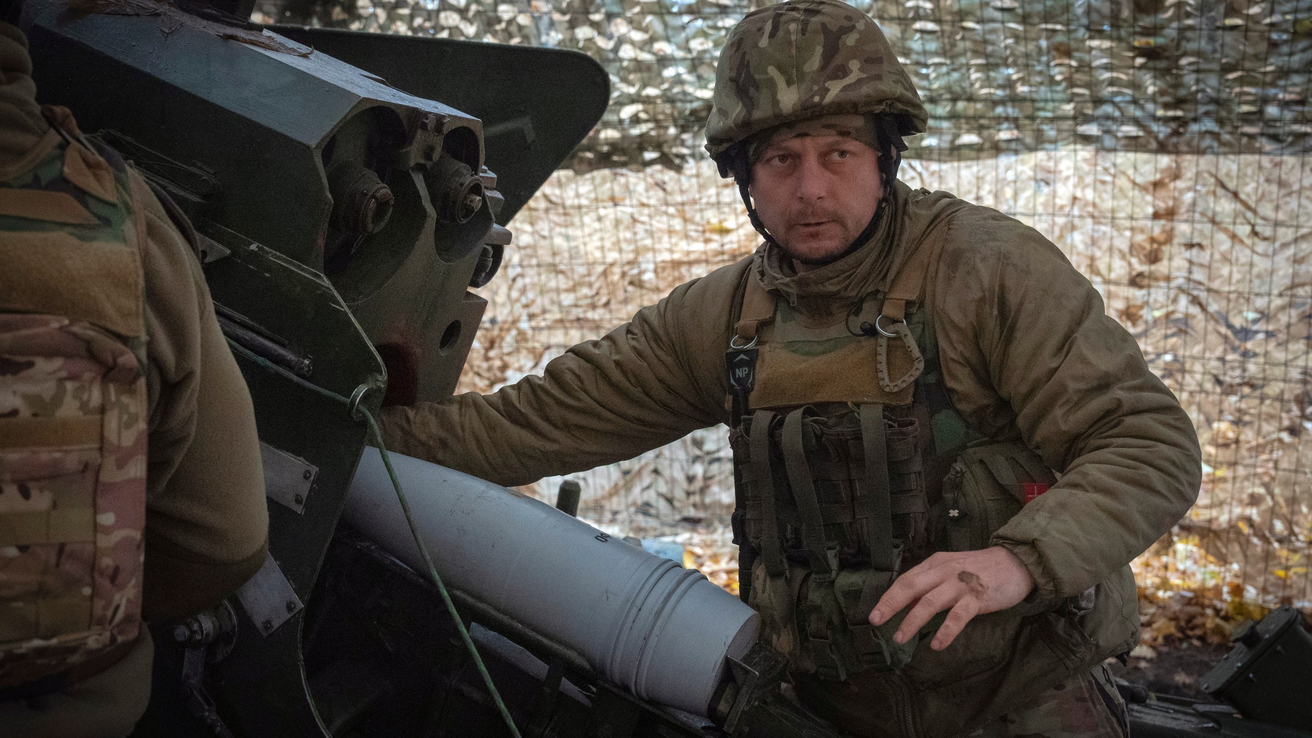 A serviceman of the 13th Brigade of the National Guard of Ukraine prepares to fire a Giatsint-B gun towards Russian positions near Kharkiv, Ukraine, Wednesday, Nov. 6, 2024. (AP Photo/Efrem Lukatsky)