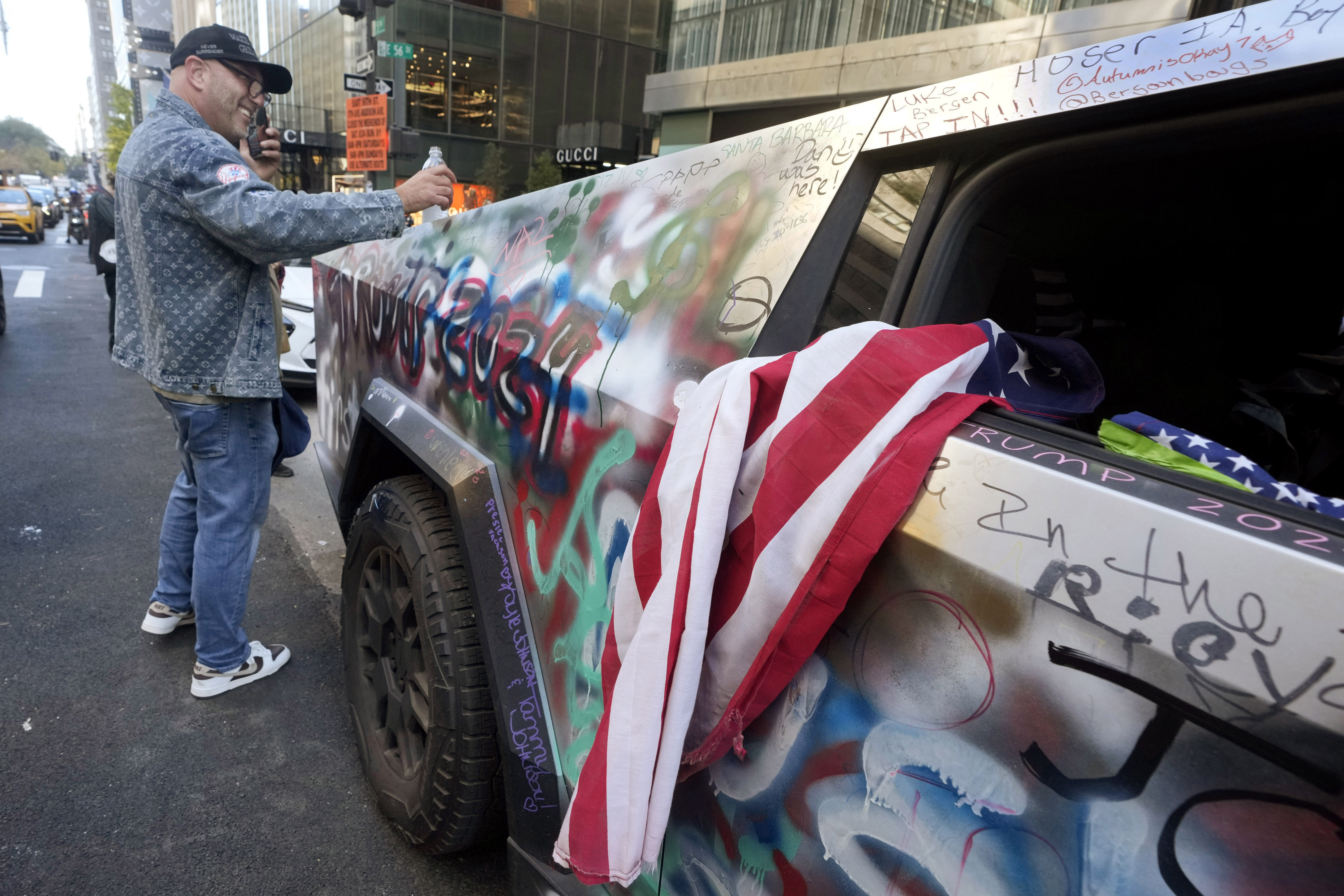 A Trump 2024-decorated Tesla Cybertruck sits parked adjacent to Trump Tower, on New York's Fifth Avenue, Tuesday, Nov. 5, 2024. (AP Photo/Richard Drew)