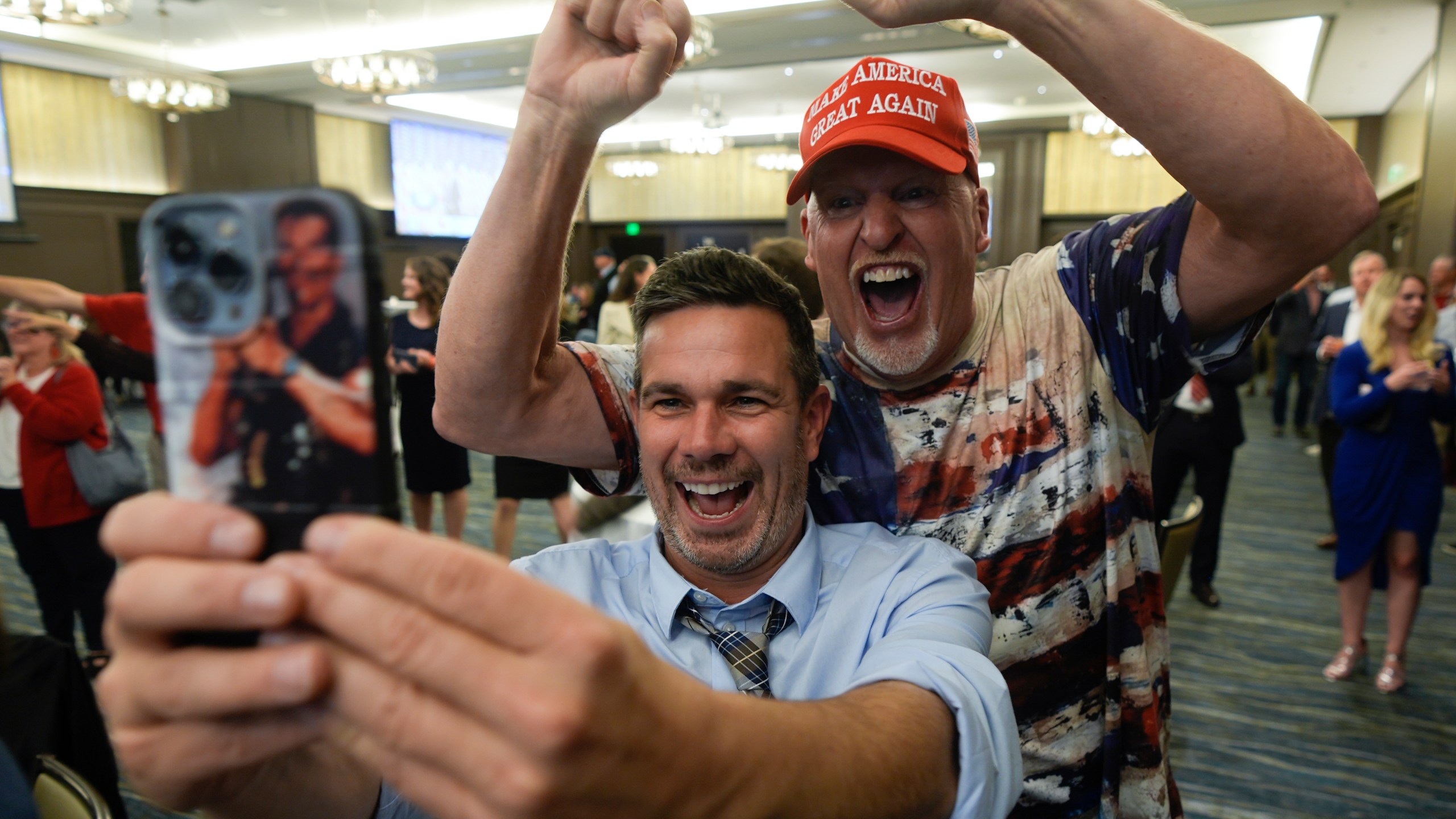 Supporters celebrate and take selfies during an election watch party for Republican U.S. Senate candidate Eric Hovde, Wednesday, Nov. 6, 2024, in Madison, Wis. (AP Photo/Morry Gash)