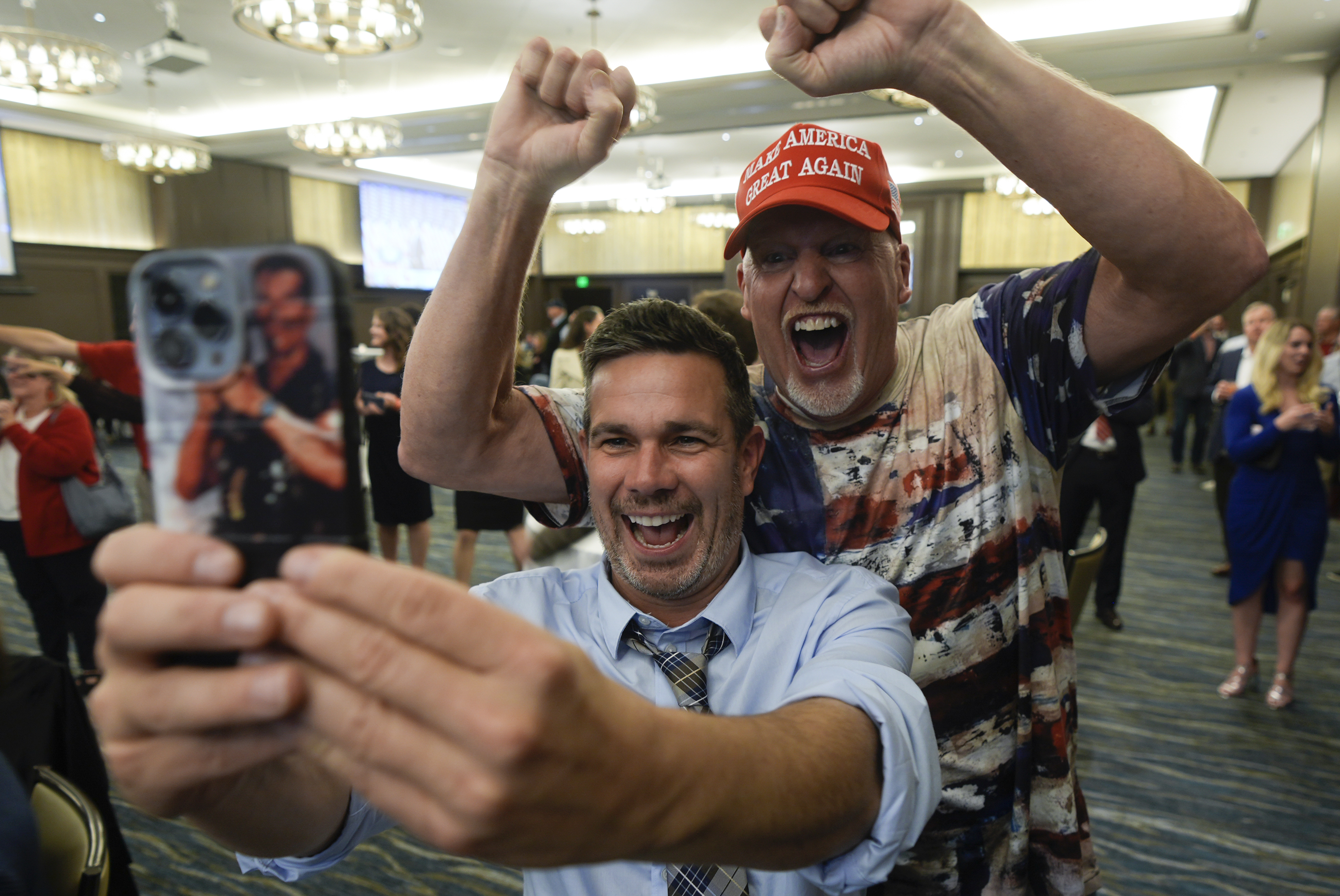 Supporters celebrate and take selfies during an election watch party for Republican U.S. Senate candidate Eric Hovde, Wednesday, Nov. 6, 2024, in Madison, Wis. (AP Photo/Morry Gash)