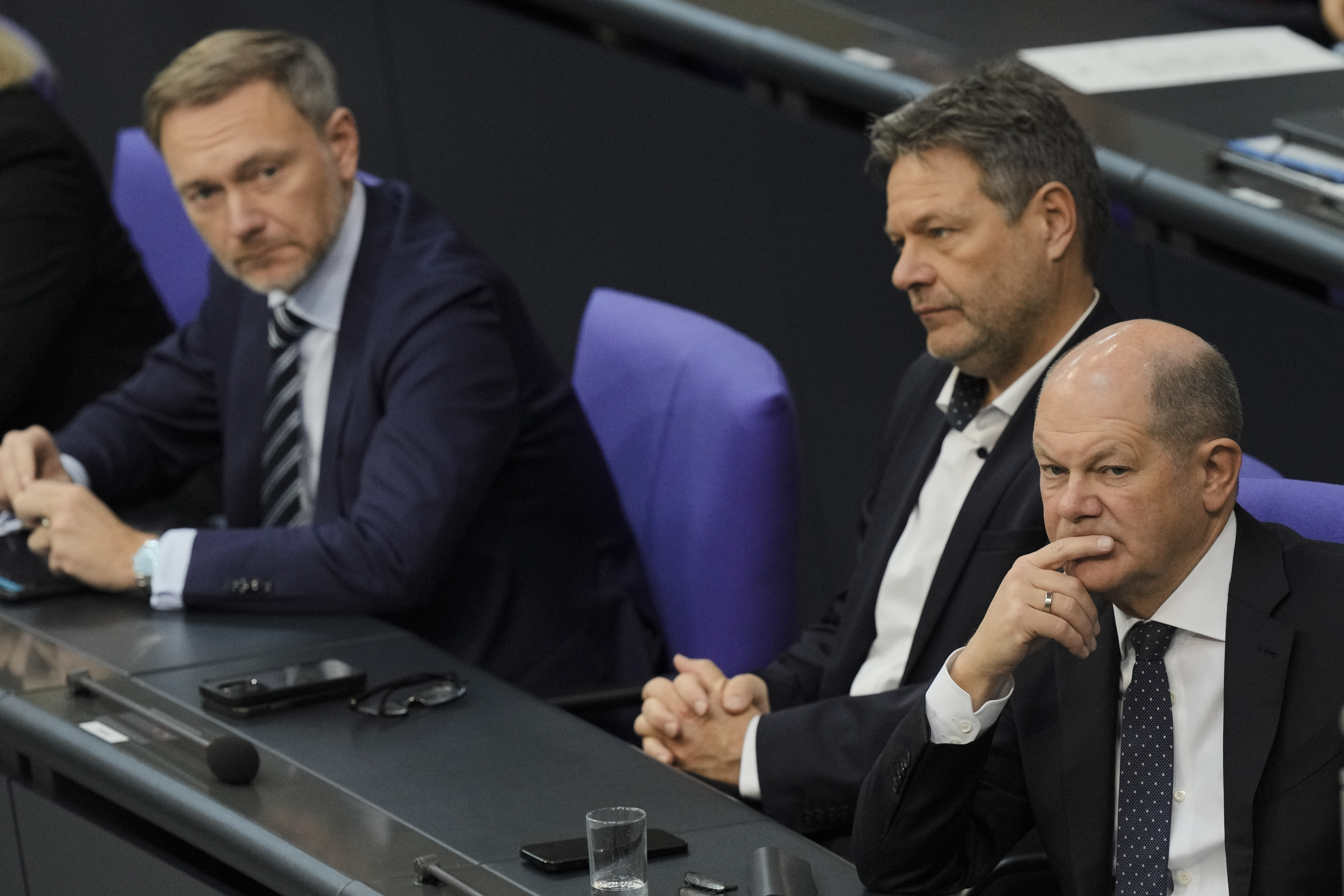 FILE - German Chancellor Olaf Scholz, right, Economy and Climate Minister Robert Habeck and Finance Minister Christian Lindner, left, listen to a debate about Germany's budget crisis at the parliament Bundestag in Berlin, Germany, Nov. 28, 2023. (AP Photo/Markus Schreiber, File)