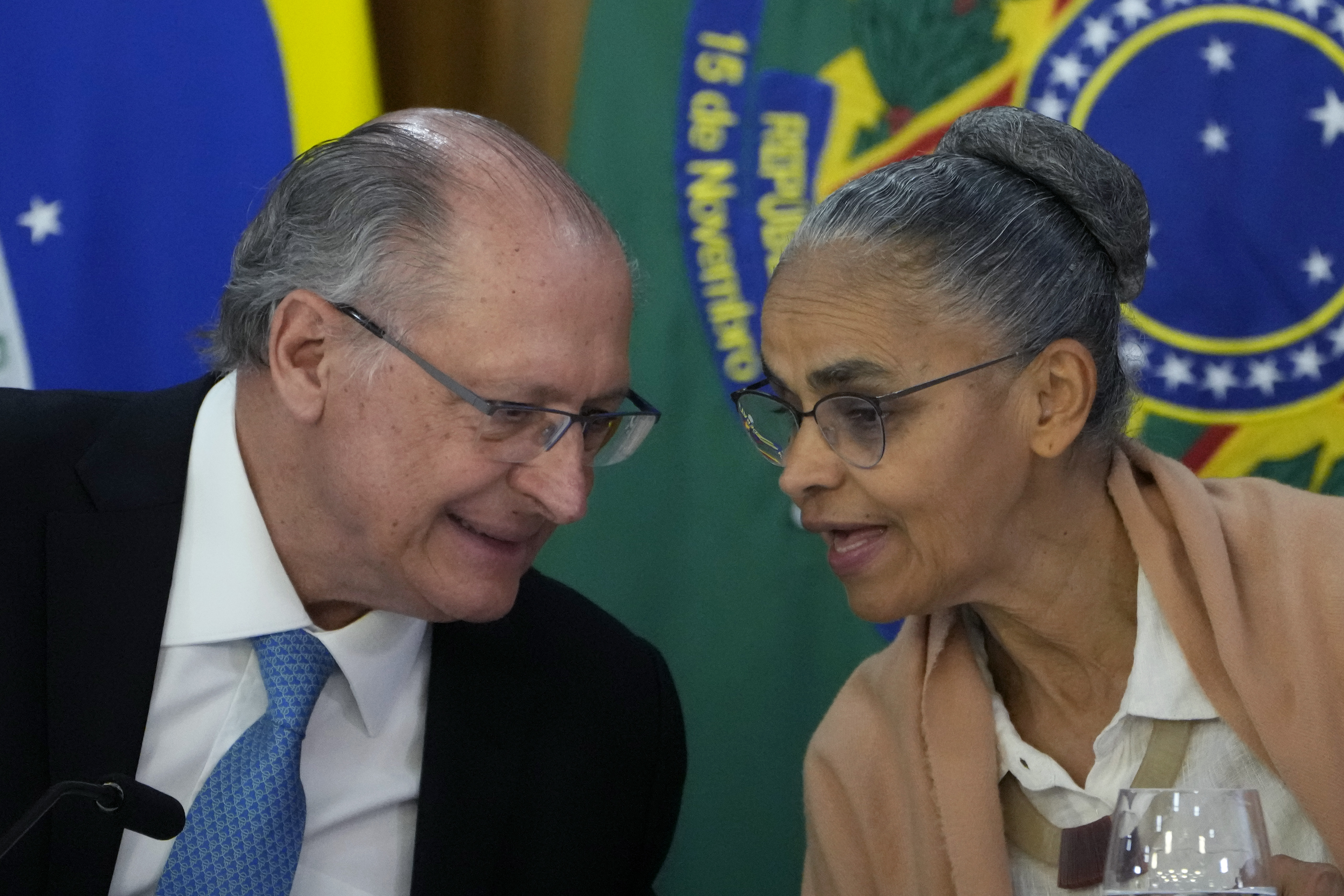 Brazil's Environment Minister Marina Silva, right, chats with Vice President Geraldo Alckmin during the announcement of a plan to combat fires and deforestation in the Amazon and the Brazilian Cerrado, at Planalto presidential palace in Brasilia, Brazil, Wednesday, Nov. 6, 2024. (AP Photo/Eraldo Peres)