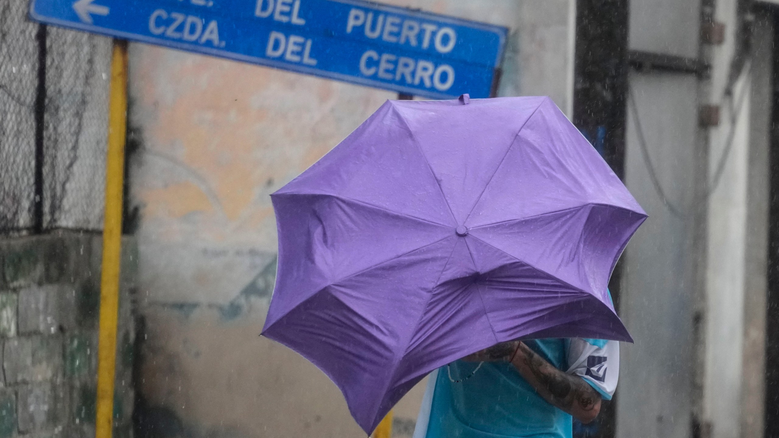 A man walks through the wind and rain brought by Hurricane Rafael in Havana, Cuba, Wednesday, Nov. 6, 2024. (AP Photo/Ramon Espinosa)