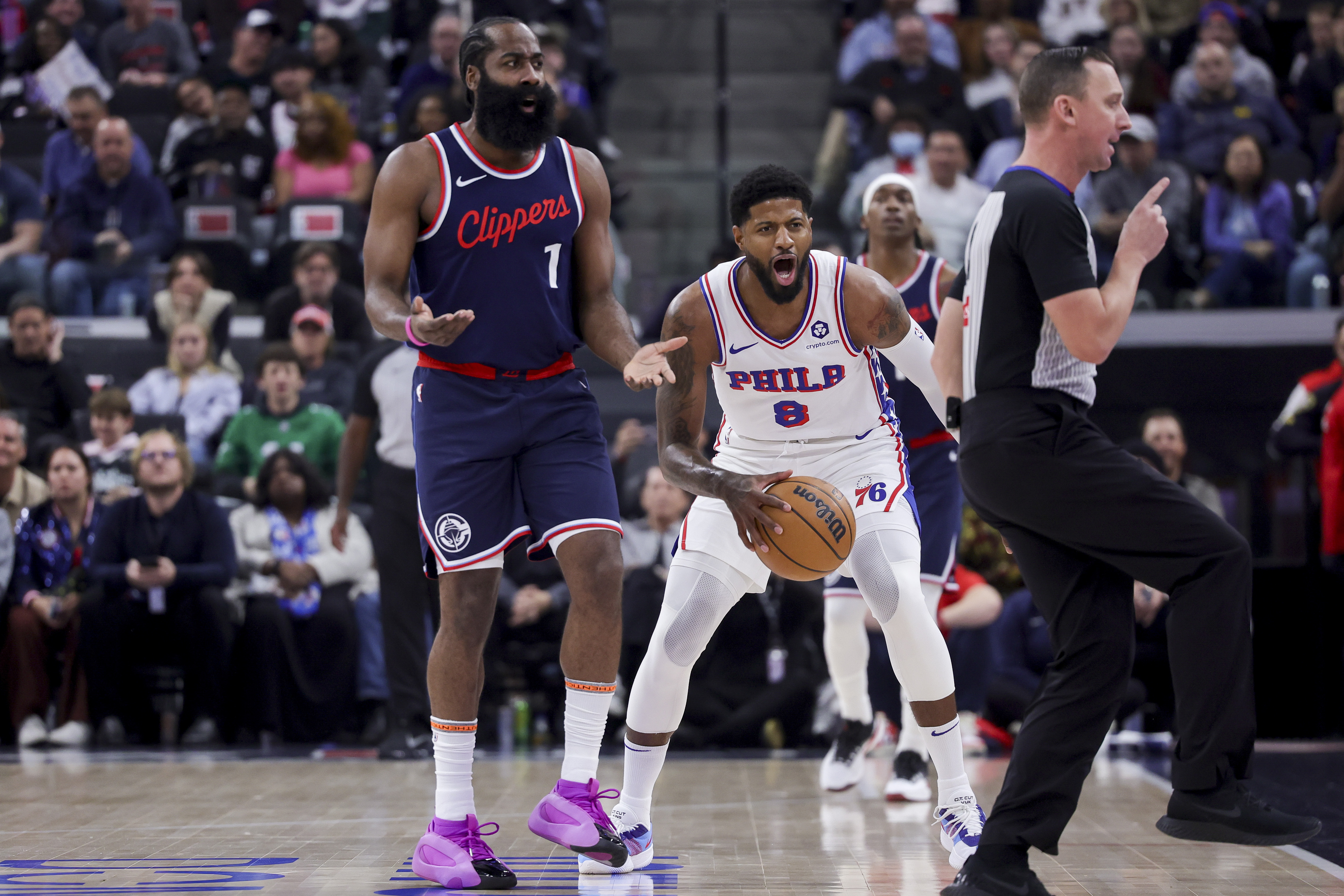 Philadelphia 76ers forward Paul George (8) and Los Angeles Clippers guard James Harden (1) react after a call during the first half of an NBA basketball game, Wednesday, Nov. 6, 2024, in Inglewood, Calif. (AP Photo/Ryan Sun)