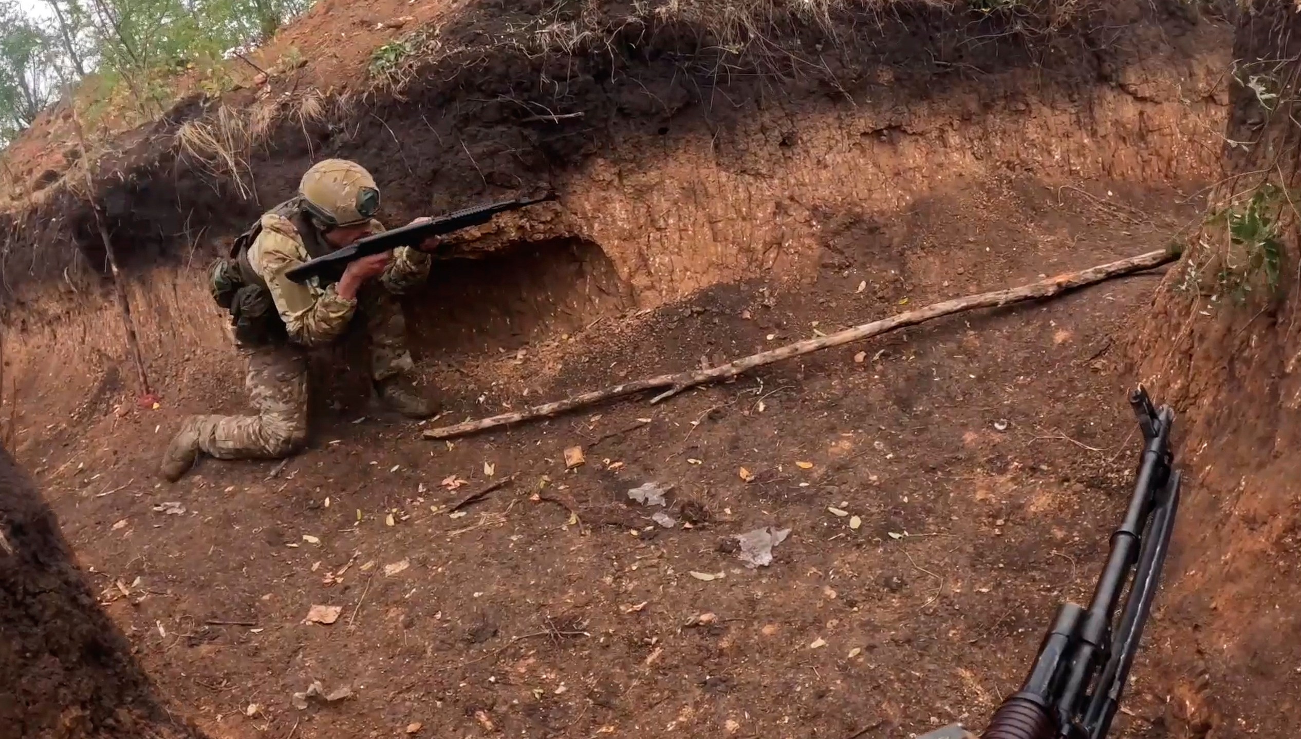 In this photo taken from a bodycam video released by Russian Defense Ministry press service on Thursday, Nov. 7, 2024, a Russian servicemen takes part in a combat training for assault units at an undisclosed location in Ukraine. (Russian Defense Ministry Press Service via AP)