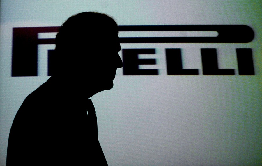 FILE -Pirelli president Marco Tronchetti Provera is silhouetted as he passes in front of the company's logo to leave at the end of a meeting in Milan, Italy, Tuesday, April 17, 2007. (AP Photo/Luca Bruno), File)