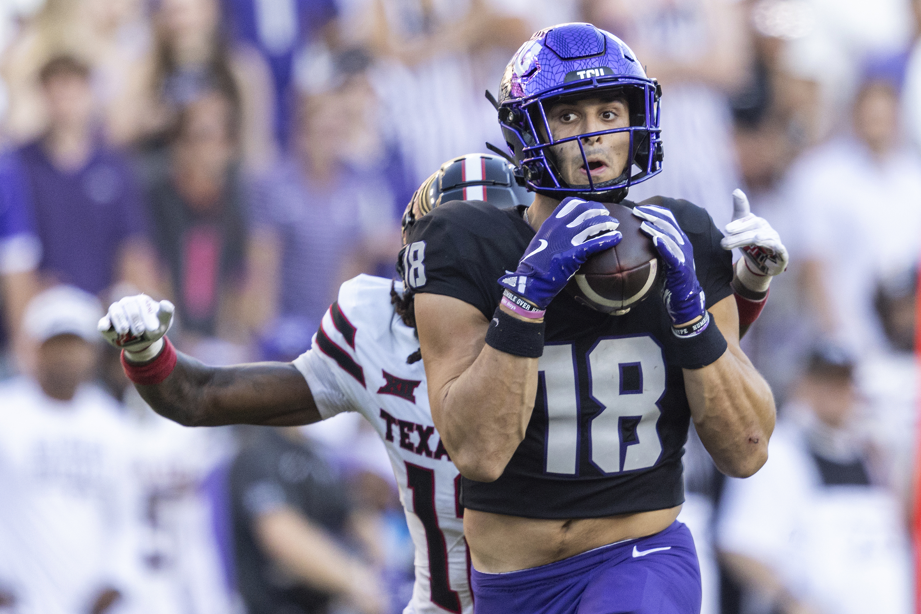 TCU wide receiver Jack Bech (18) catches a long pass from quarterback Josh Hoover (10) while guarded by Texas Tech defensive back Macho Stevenson (12) in the second half of an NCAA college football game in Fort Worth, Texas, Saturday, Oct. 26, 2024. (Chris Torres/Star-Telegram via AP)