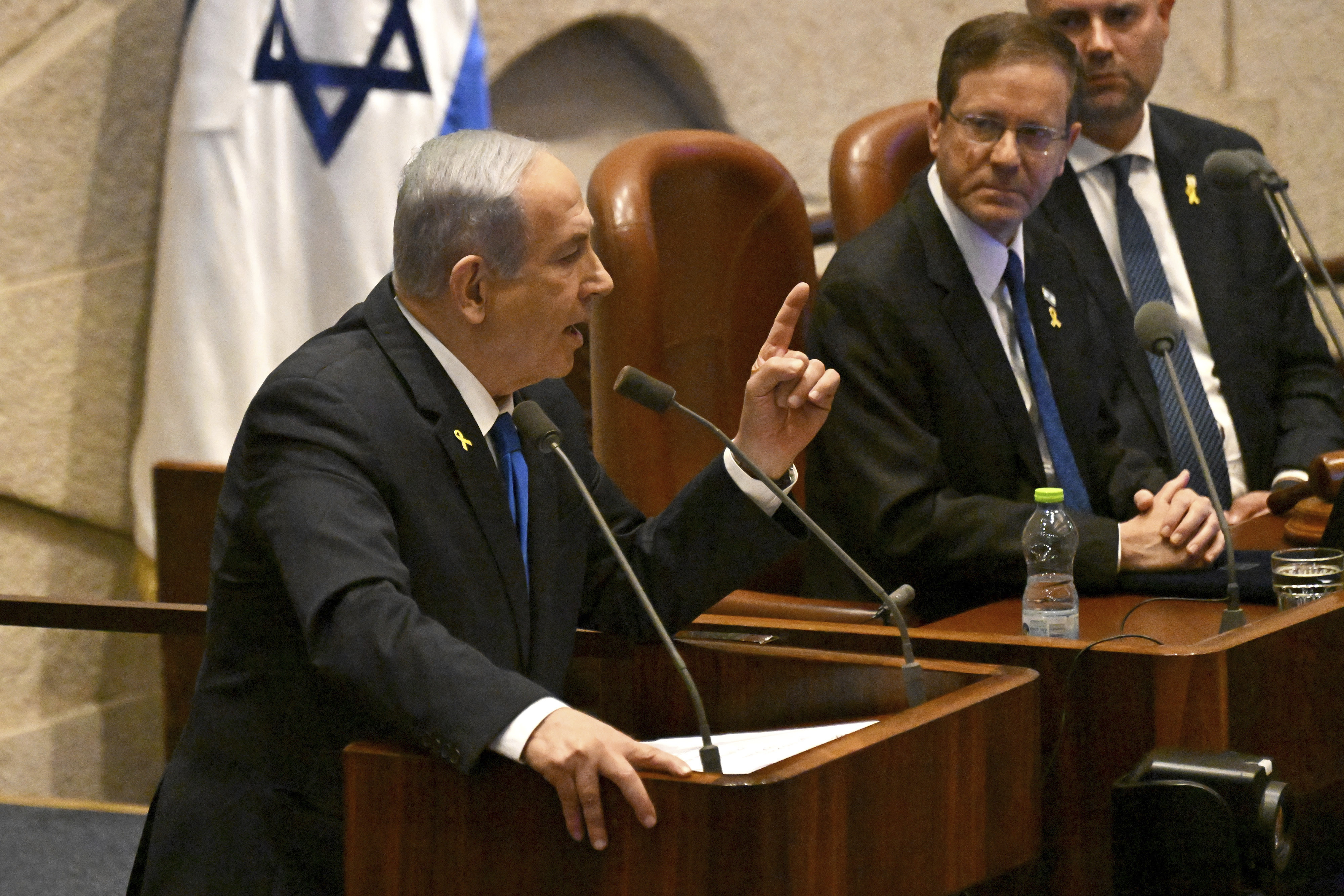 Israeli Prime Minister Benjamin Netanyahu speaks at the opening of the 25th Knesset session marking the anniversary of the "Iron Swords" war, in Jerusalem, Monday, Oct. 28, 2024. (Debbie Hill/Pool Photo via AP)