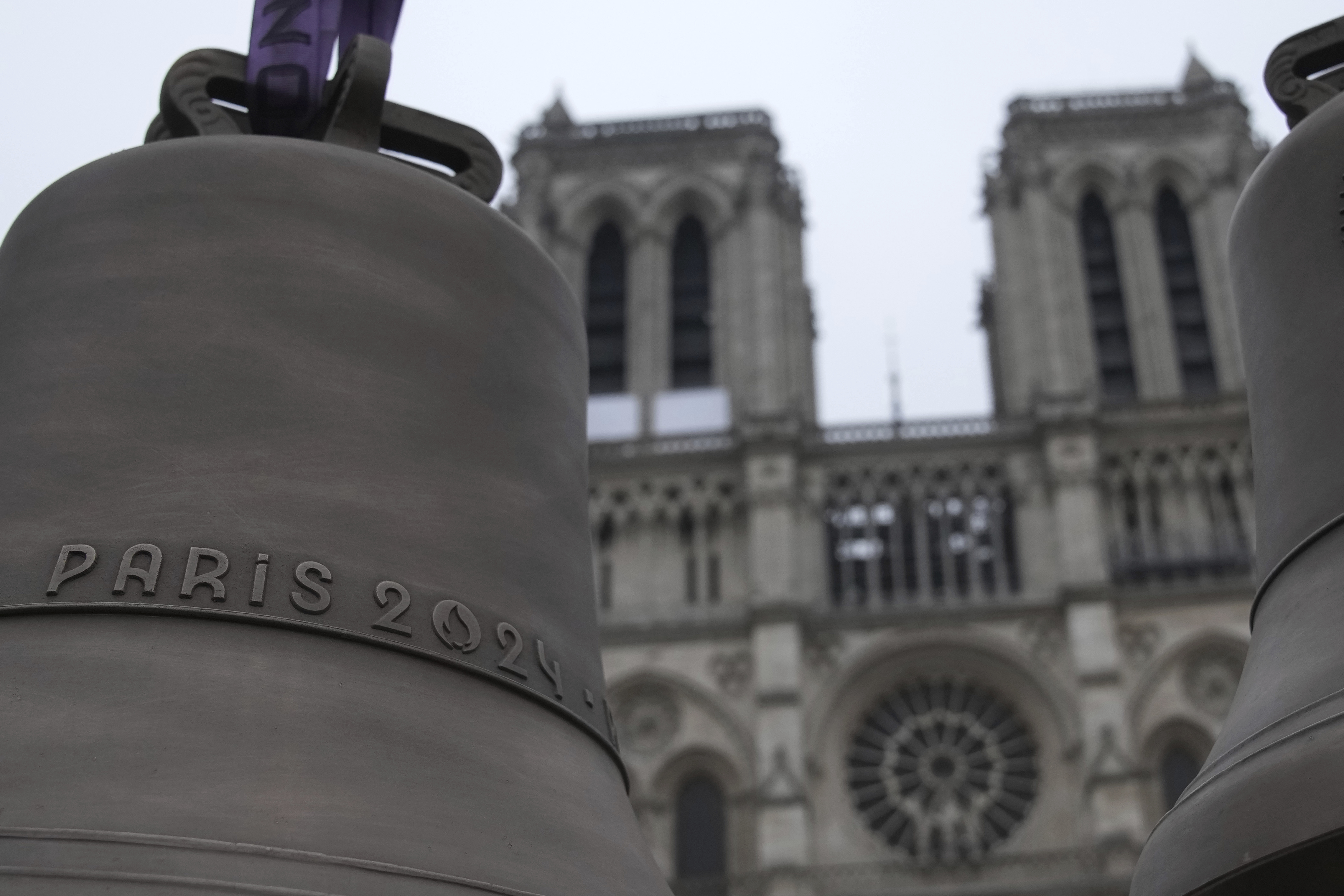 The bell that Olympic medalists rang at the Paris Games, left, and another bell are seen before their installation in Notre-Dame cathedral, ahead of the monument's grandiose reopening following a massive fire and five-year reconstruction effort, Thursday, Nov. 7, 2024 in Paris. (AP Photo/Christophe Ena)