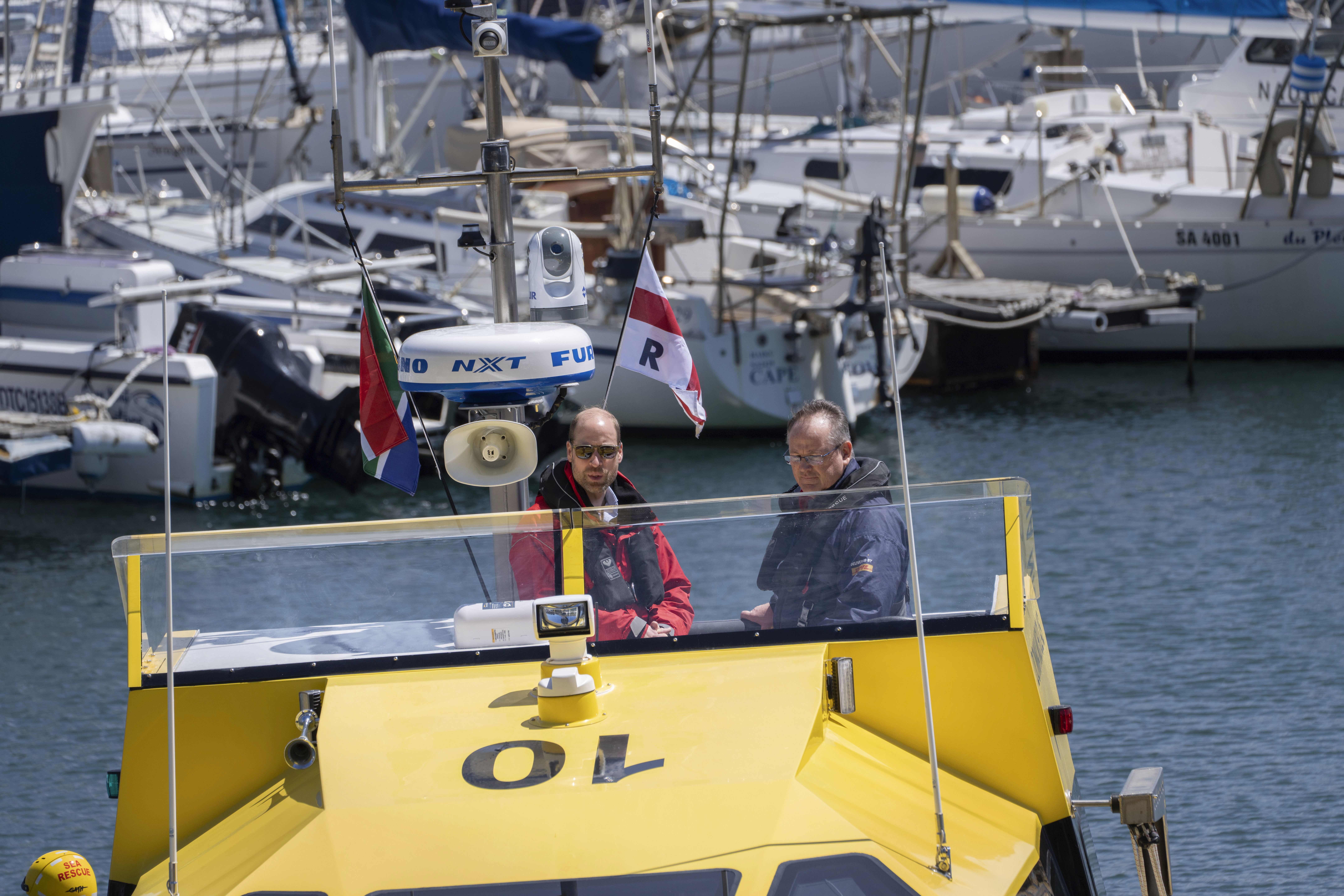 Britain's Prince William sails off with volunteers of the National Sea Rescue Initiative, at Simon's Town harbour near Cape Town, South Africa, Thursday, Nov. 7, 2024. (AP Photo/Jerome Delay, Pool)