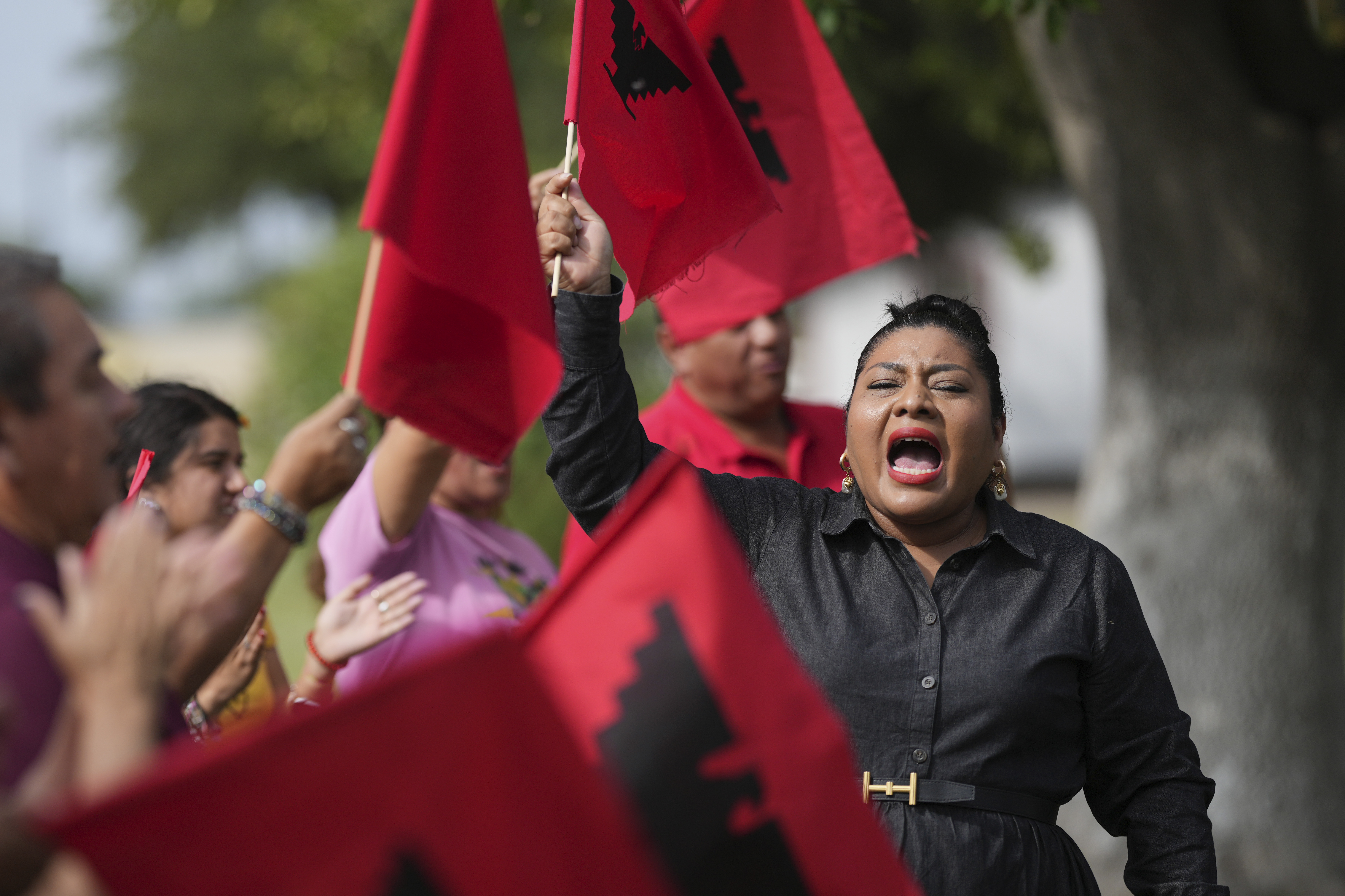 Tania Chavez, right, executive director of La Unión del Pueblo Entero (LUPE), leads members in a chant after making statements about yesterday's election, in San Juan, Texas, Wednesday, Nov. 6, 2024. (AP Photo/Eric Gay)