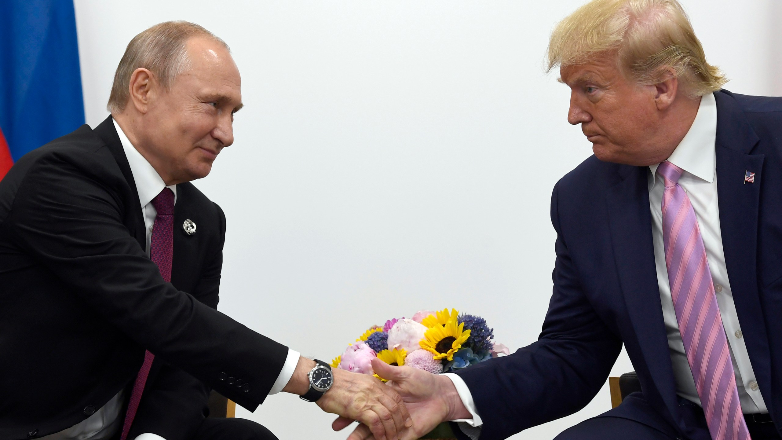 FILE - In this June 28, 2019, file photo, President Donald Trump, right, shakes hands with Russian President Vladimir Putin, left, during a bilateral meeting on the sidelines of the G-20 summit in Osaka, Japan. (AP Photo/Susan Walsh, File)