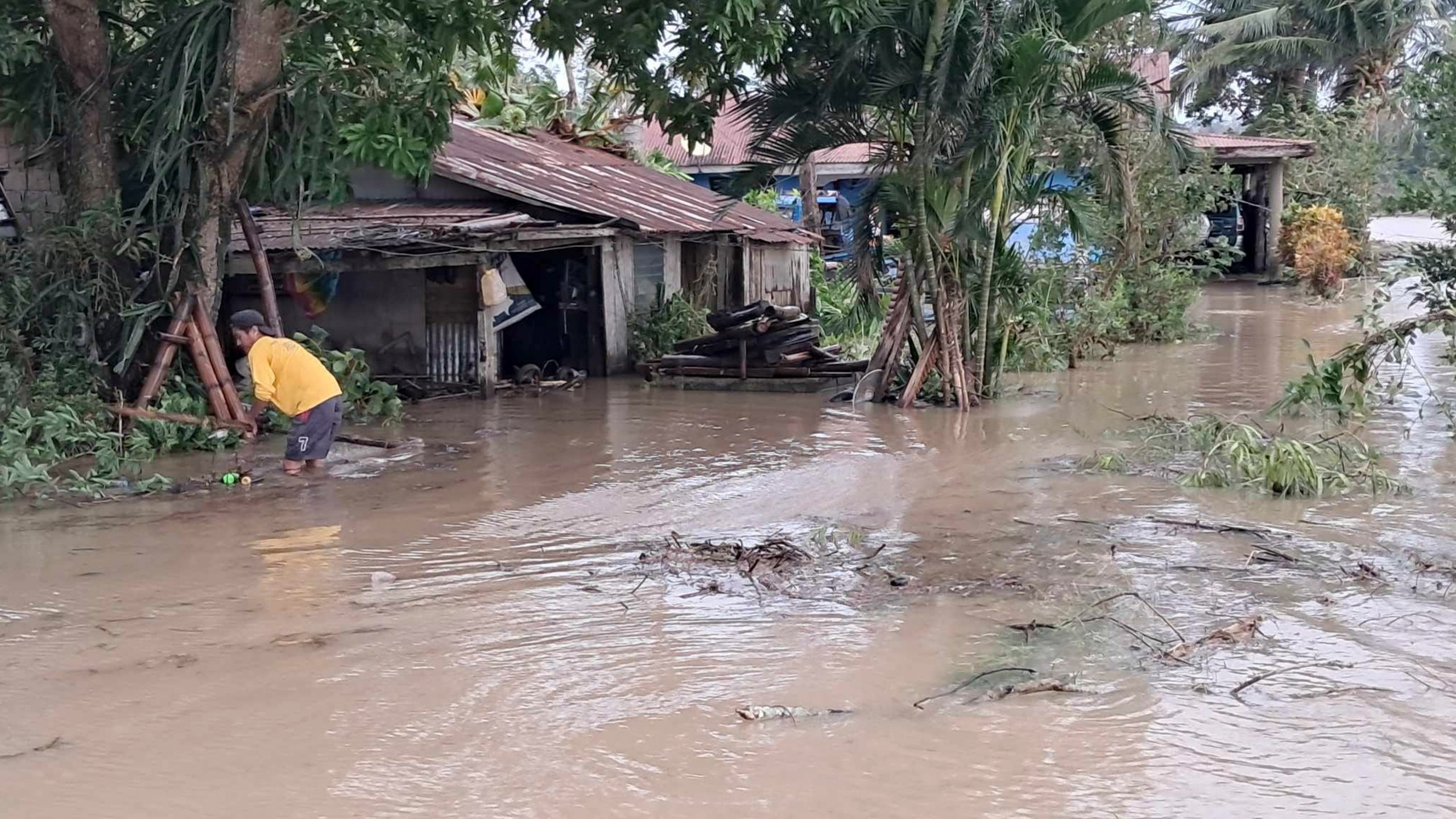 In this photo provided by the Local Government Unit (LGU) of Lal-lo, a resident wades along flooded areas caused by Typhoon Yinxing in Lal-lo, Cagayan province, northern Philippines Friday, Nov. 8, 2024. (LGU Lal-lo via AP)