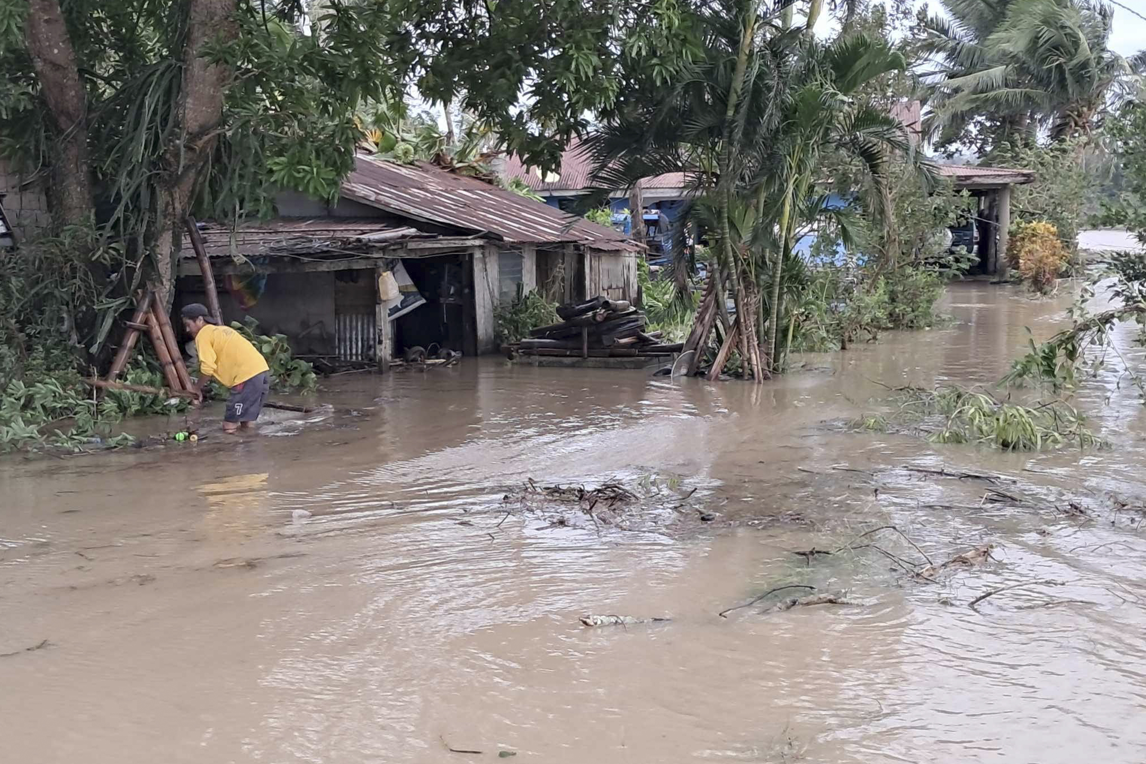 In this photo provided by the Local Government Unit (LGU) of Lal-lo, a resident wades along flooded areas caused by Typhoon Yinxing in Lal-lo, Cagayan province, northern Philippines Friday, Nov. 8, 2024. (LGU Lal-lo via AP)