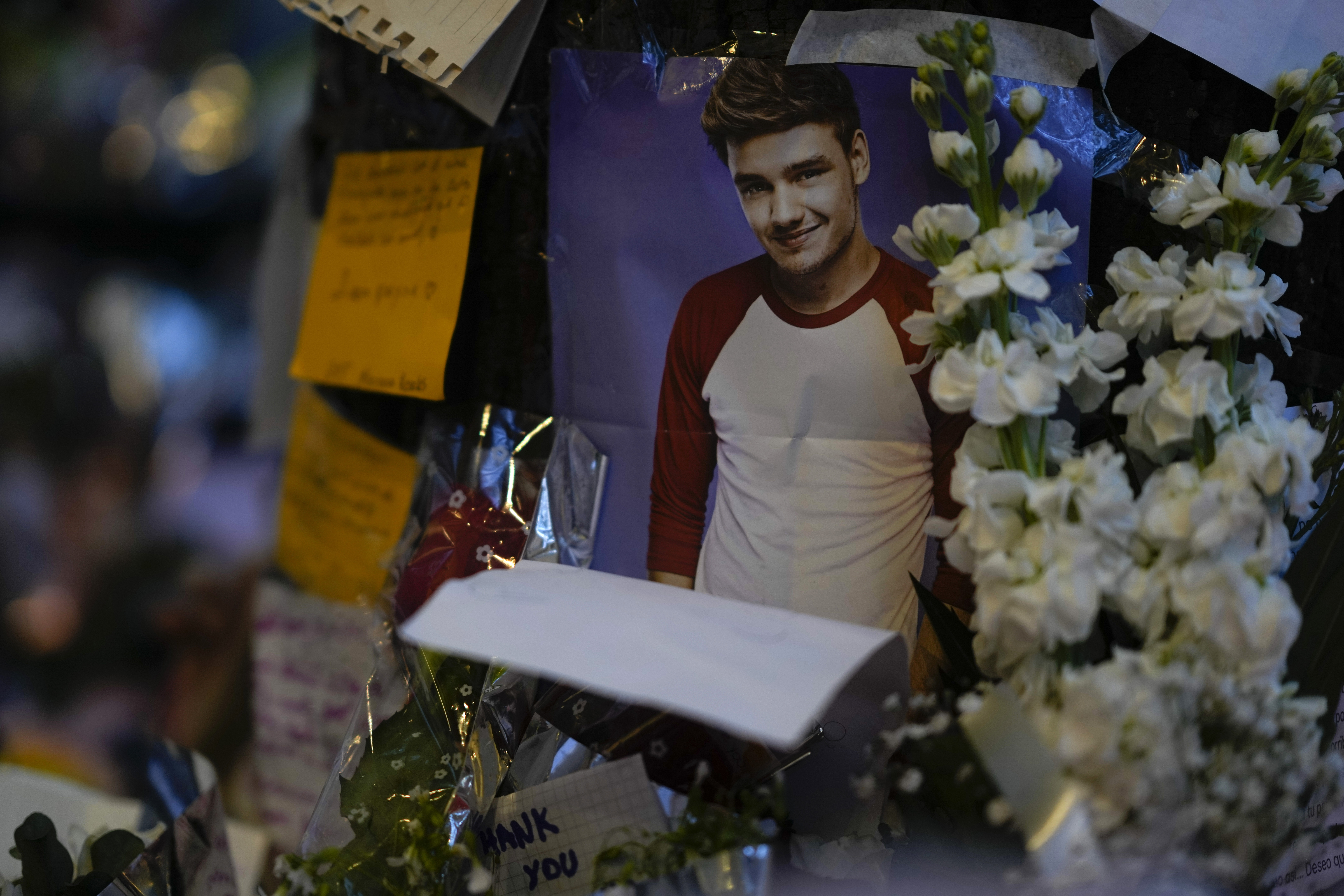 A picture of former One Direction singer Liam Payne adorns a memorial outside the hotel where he was found dead after falling from a balcony in Buenos Aires, Argentina, Thursday, Oct. 17, 2024. (AP Photo/Natacha Pisarenko)