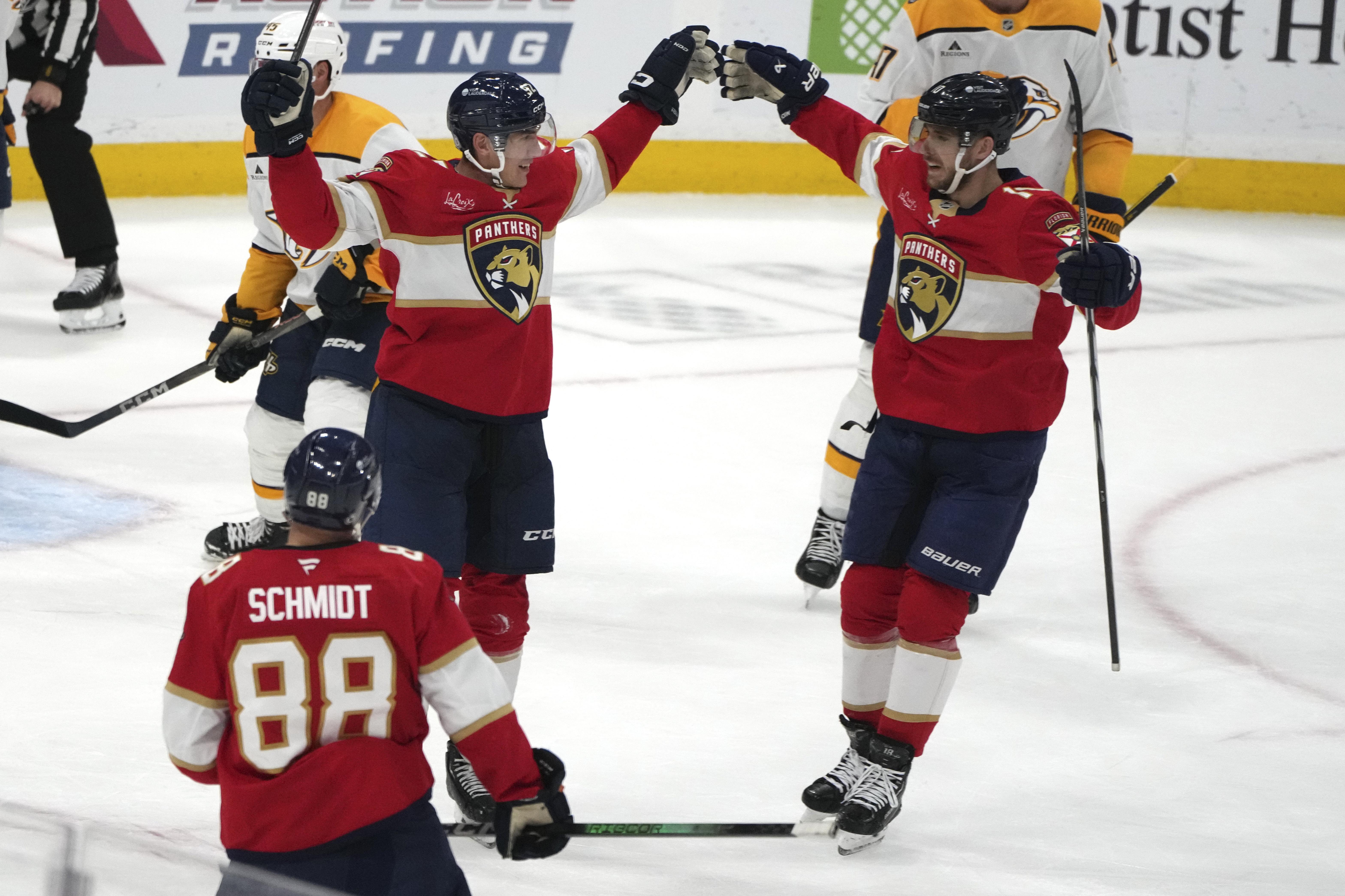 Florida Panthers left wing Tomas Nosek, left, celebrates with left wing A.J. Greer, right, after scoring a goal during the third period of an NHL hockey game against the Nashville Predators, Thursday, Nov. 7, 2024, in Sunrise, Fla. (AP Photo/Lynne Sladky)