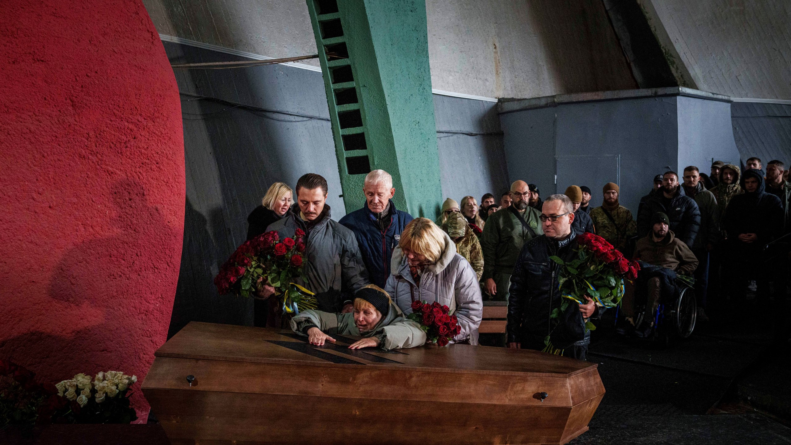 The mother cries over the coffin of her daughter Valentyna Nagorna aka "Valkiria", Ukrainian military medic of 3rd assault brigade who was killed together with his boyfriend Danylo Liashkevych aka "Berserk, during the funeral ceremony at crematorium in Kyiv, Ukraine, Friday, Nov. 8, 2024. (AP Photo/Evgeniy Maloletka)