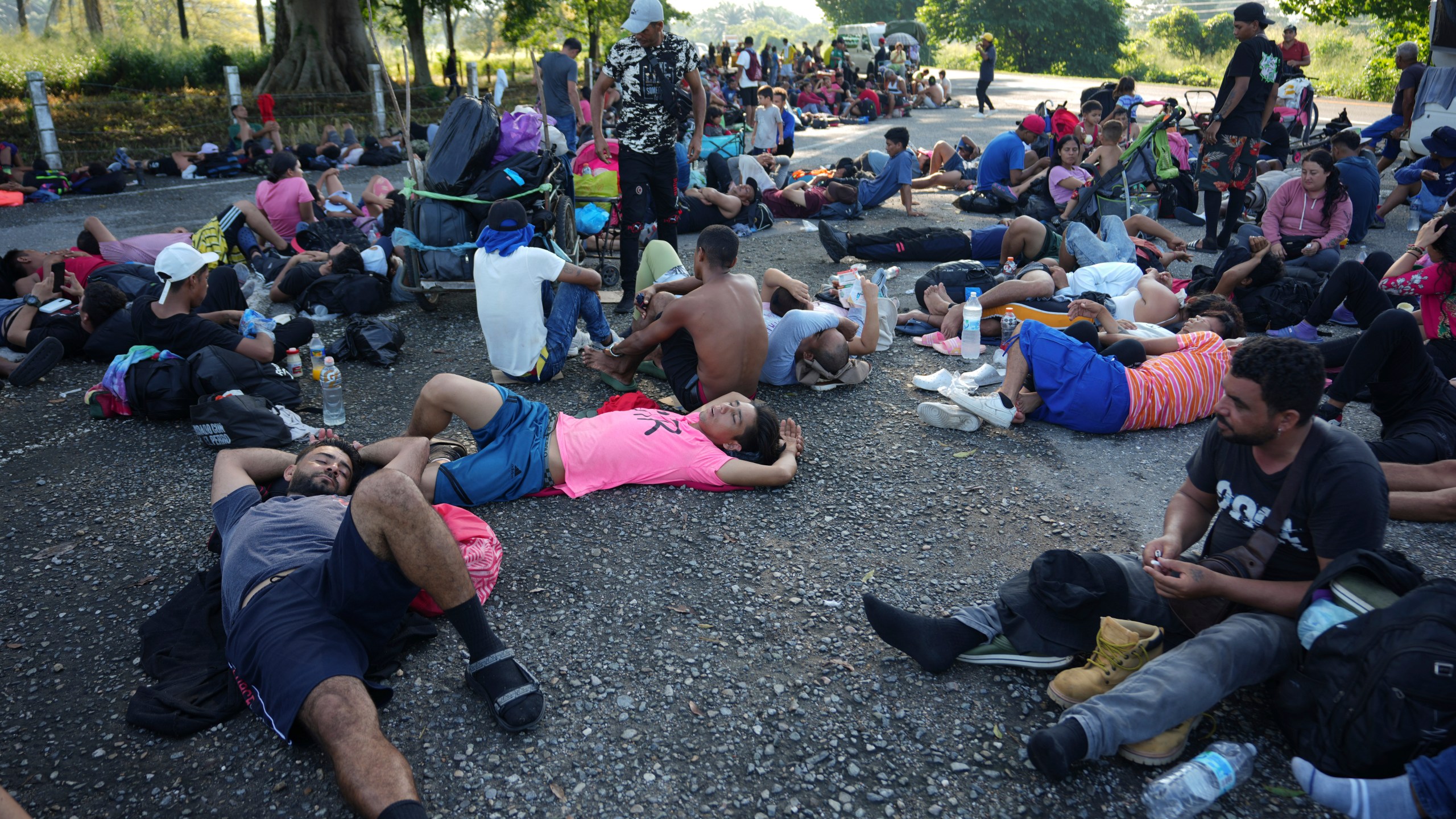 Migrants, who are part of a caravan heading toward the country's northern border and ultimately the United States, rest on the outskirts of Escuintla, southern Mexico, Thursday, Nov. 7, 2024. (AP Photo/Moises Castillo)