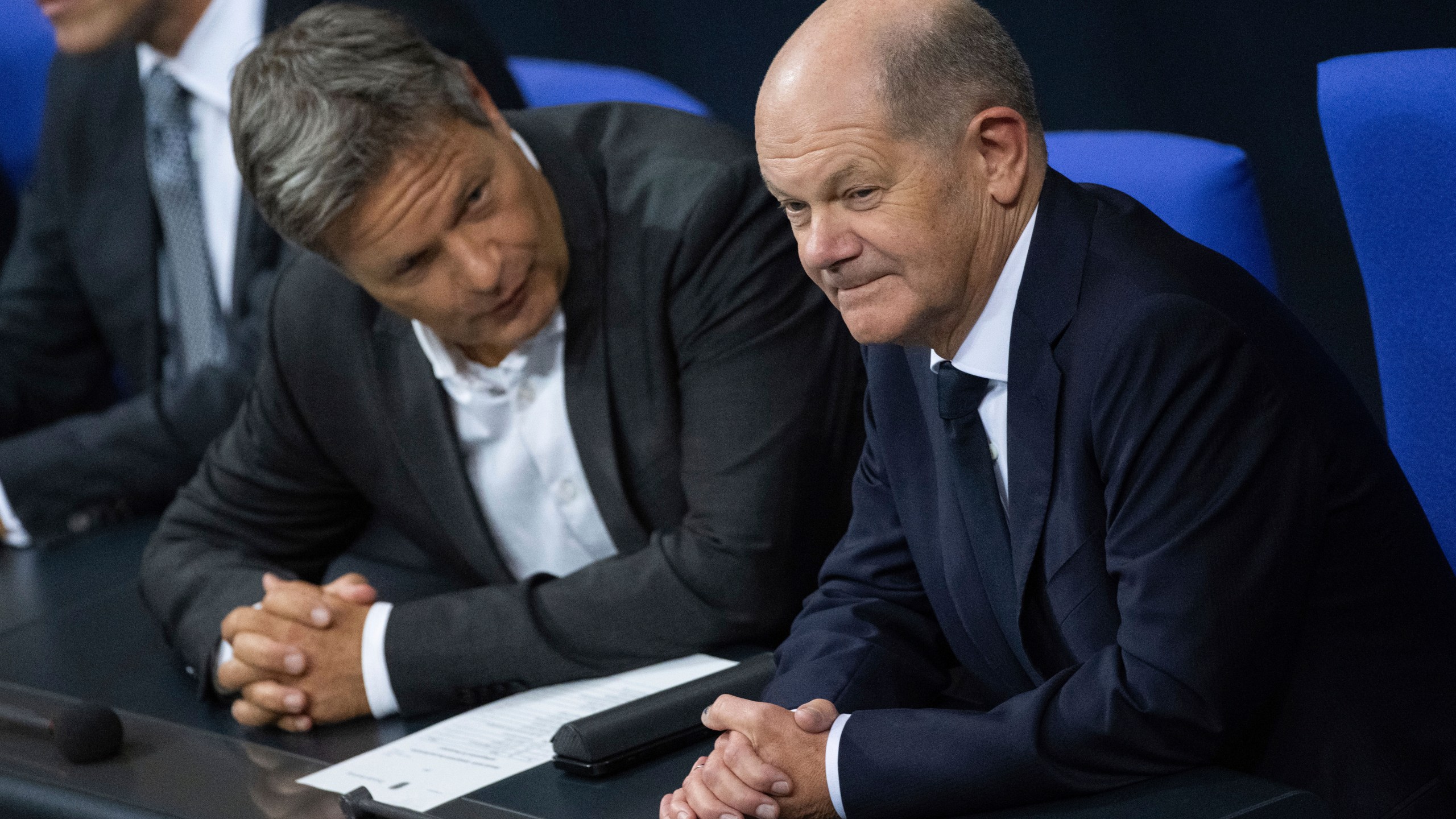 German Economy and Climate Minister Robert Habeck, left, talks to German Chancellor Olaf Scholz, right, during a meeting of the German federal parliament, Bundestag, at the Reichstag building in Berlin, Germany, Thursday, Nov. 7, 20024. (Christophe Gateau/dpa via AP)