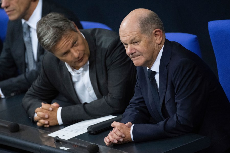 German Economy and Climate Minister Robert Habeck, left, talks to German Chancellor Olaf Scholz, right, during a meeting of the German federal parliament, Bundestag, at the Reichstag building in Berlin, Germany, Thursday, Nov. 7, 20024. (Christophe Gateau/dpa via AP)