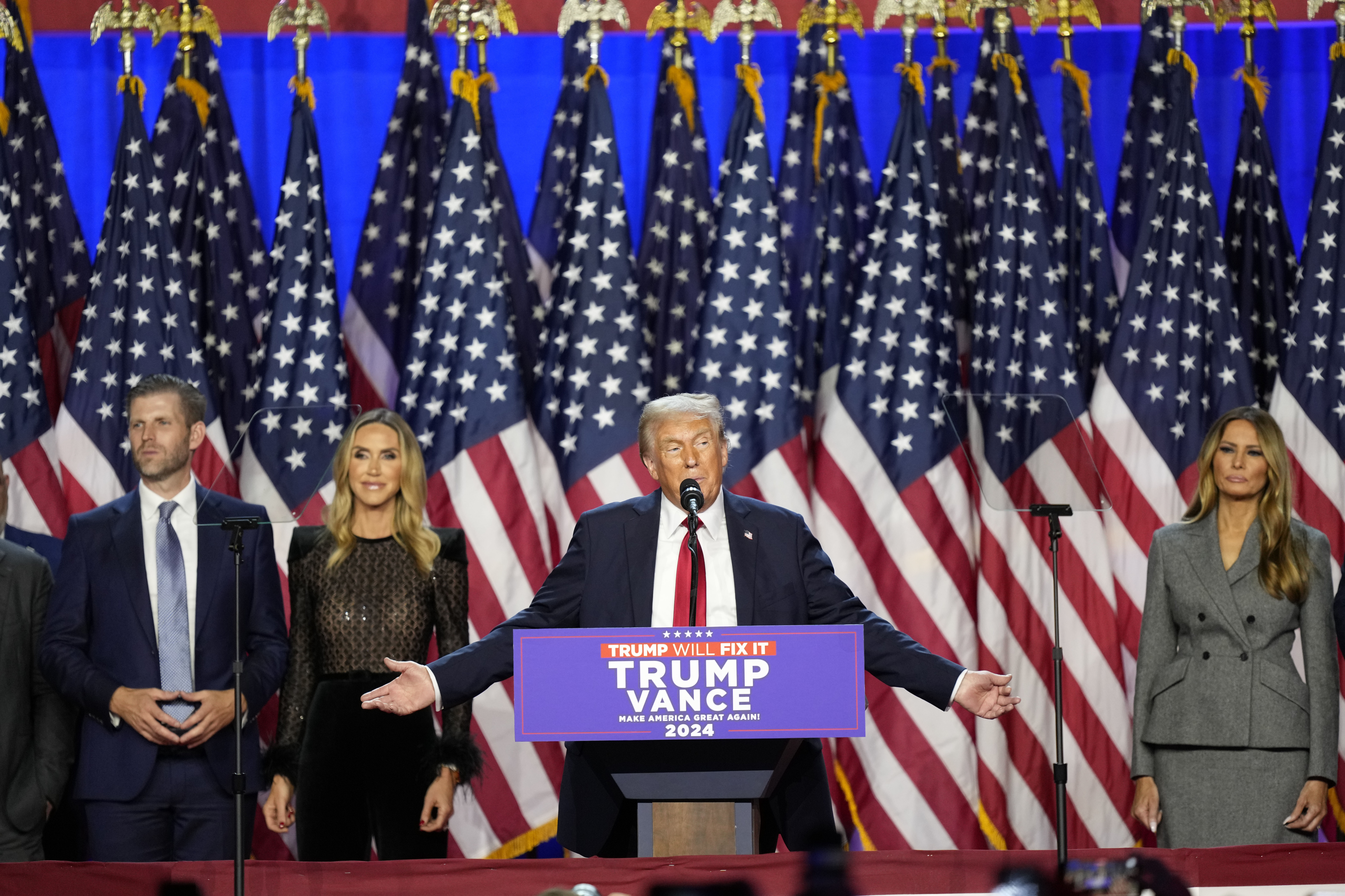 Republican presidential nominee former President Donald Trump speaks at an election night watch party Wednesday, Nov. 6, 2024, in West Palm Beach, Fla., as Eric Trump, Republican National Committee co-chair Lara Trump and Melania Trump listen. (AP Photo/Alex Brandon)