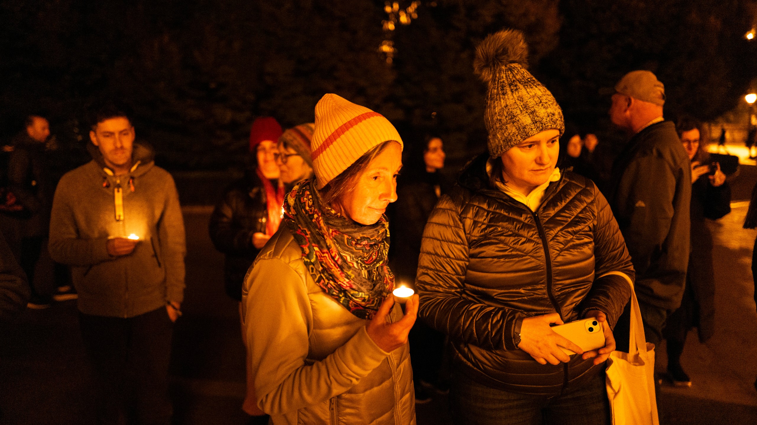 Friends hold candles while remembering Mackenzie Michalski, an 31-year-old American tourist who was murdered while on vacation, during a candlelight vigil in Budapest, Hungary, Saturday, Nov. 9, 2024. (AP Photo/Bela Szandelszky)