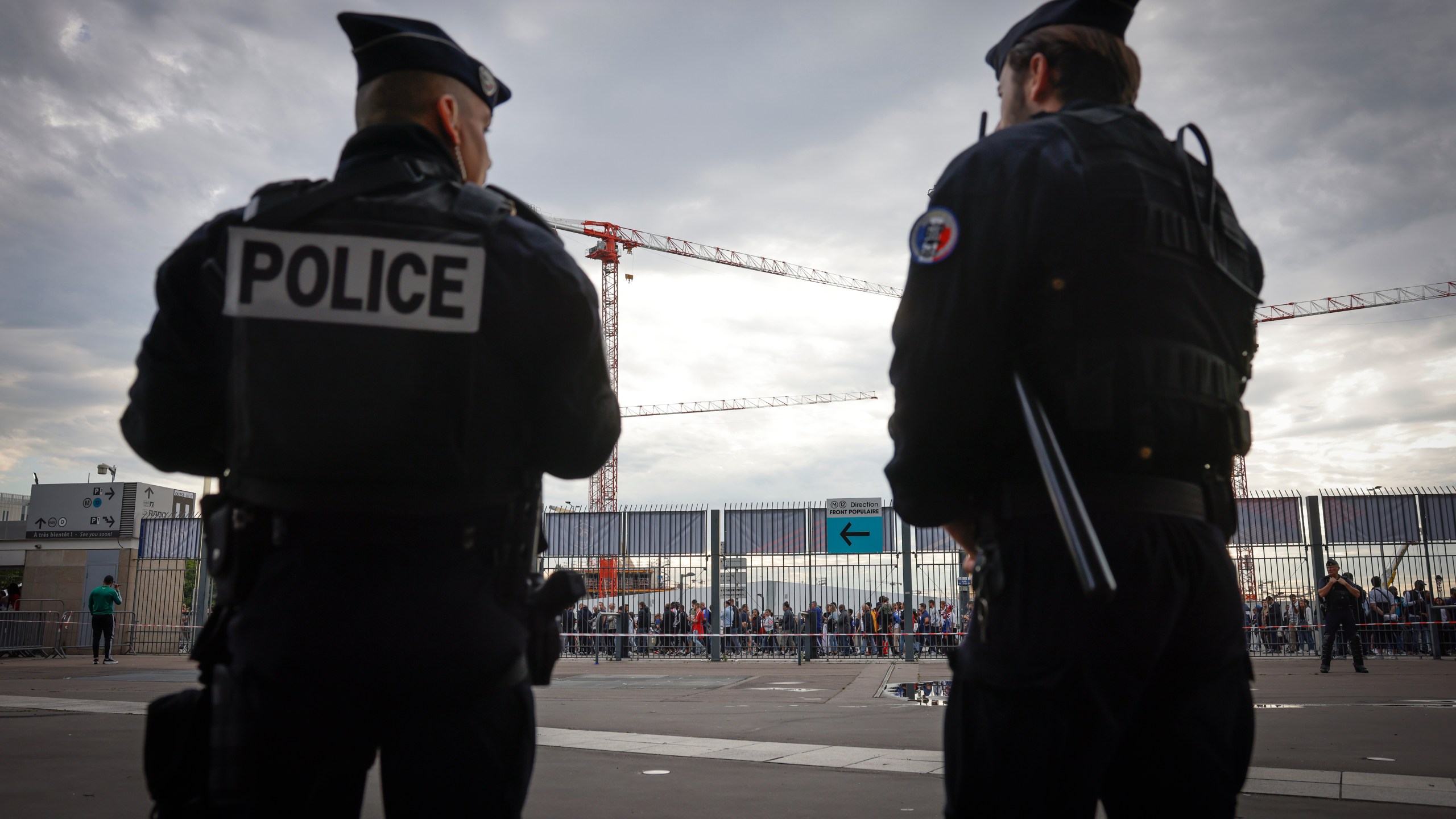 FILE - Police officers stand guard ahead the UEFA Nations League soccer match between France and Denmark at the Stade de France in Saint Denis near Paris, France, Friday, June 3, 2022. (AP Photo/Jean-Francois Badias, File)