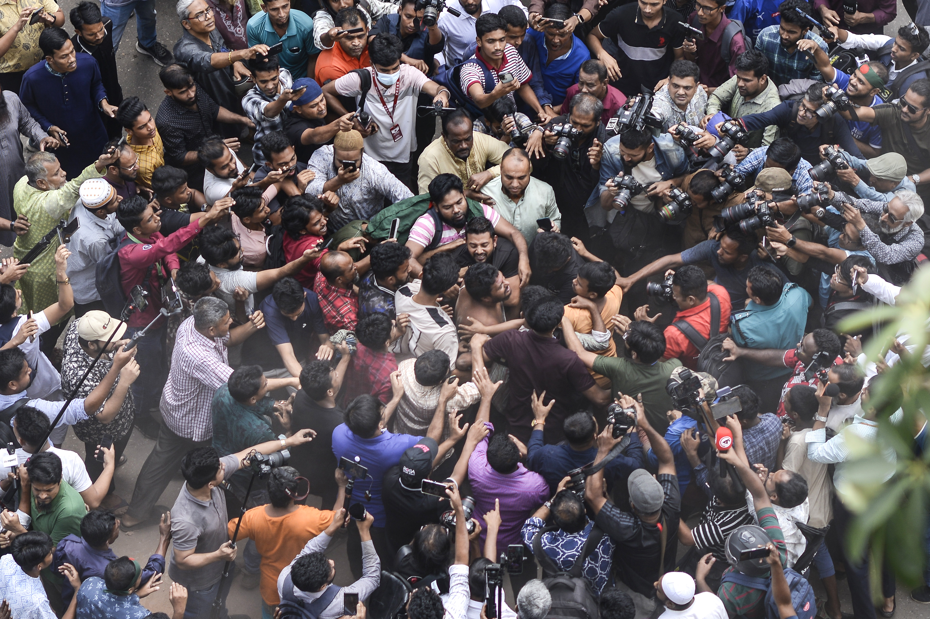 Students from anti-discrimination movements and Bangladesh Nationalist Party activists attack an Awami League supporter in Dhaka, Bangladesh, Sunday, Nov. 10, 2024. (AP Photo/Mahmud Hossain Opu)