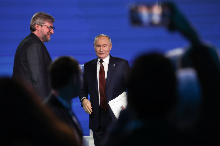 Russian President Vladimir Putin, center, leaves a meeting with foreign policy experts at the Valdai Discussion Club in the Black Sea resort of Sochi, Russia, early Friday, Nov. 8, 2024. (Maxim Shipenkov/Pool Photo via AP)