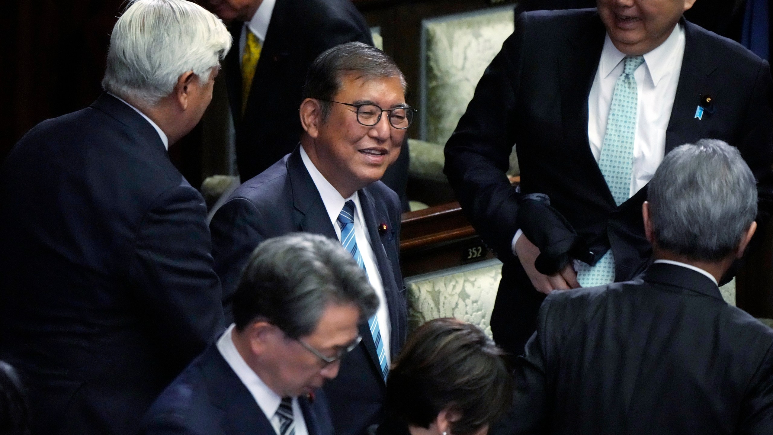 Japanese Prime Minister Shigeru Ishiba, center, reacts as he was elected for a new prime minister at a special parliamentary session of the lower house Monday, Nov. 11, 2024, in Tokyo. (AP Photo/Eugene Hoshiko)