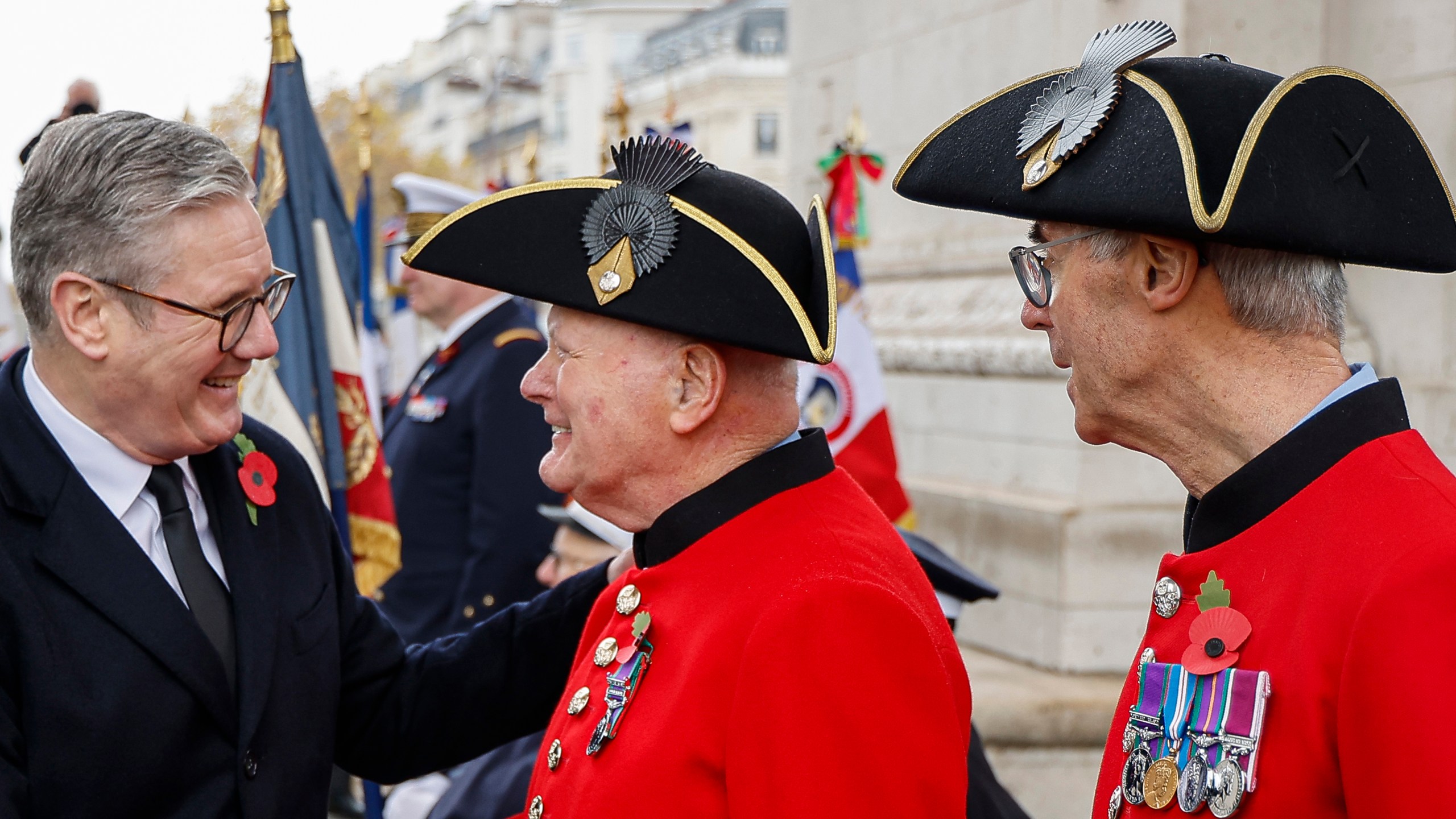 Britain's Prime Minister Keir Starmer greets Chelsea Pensioners during commemorations marking the 106th anniversary of the November 11, 1918, Armistice, ending World War I, at the Arc de Triomphe in Paris, Monday, Nov. 11, 2024. ( Ludovic Marin, Pool via AP)