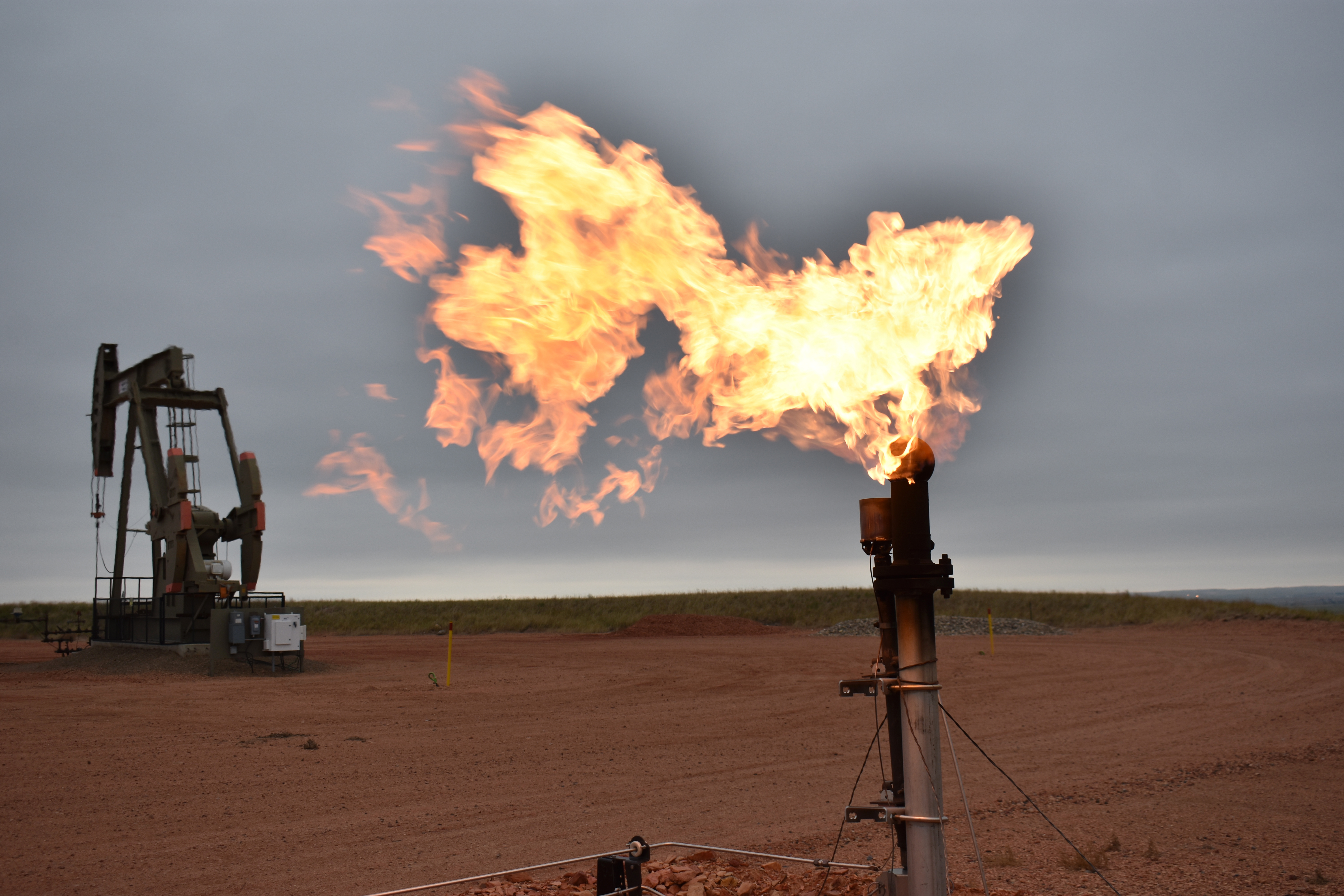 FILE - A flare burns natural gas at an oil well in Watford City, N.D., Aug. 26, 2021. (AP Photo/Matthew Brown, File)