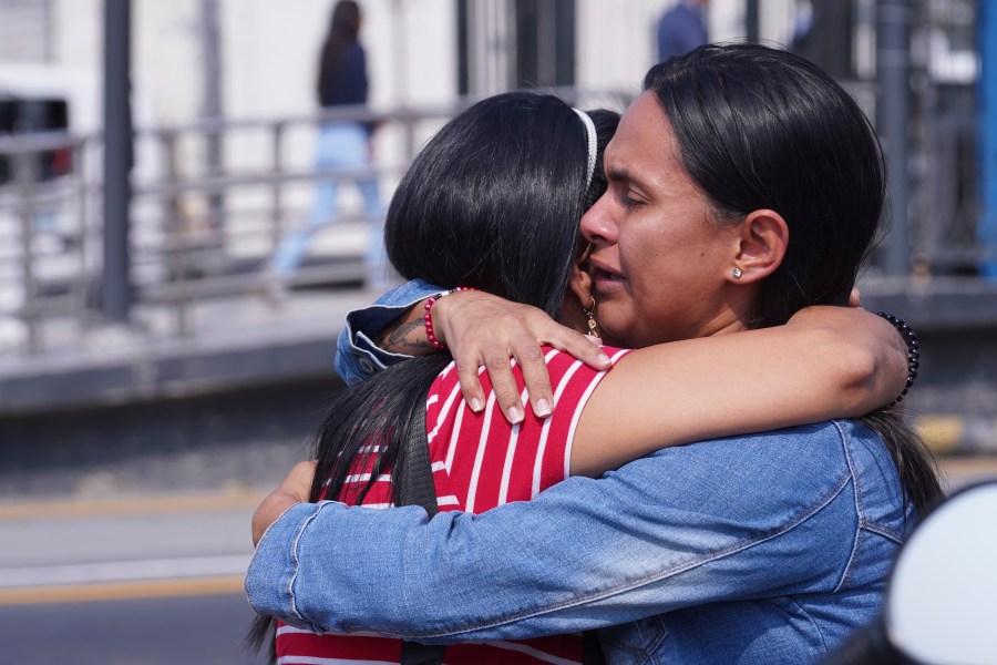 Inmates' relatives embrace outside the Litoral Penitentiary in the coastal city of Guayaquil, Ecuador, Tuesday, Nov. 12, 2024, where a fight among inmates has left at least more than a dozen dead authorities said. (AP Photo/Cesar Munoz)