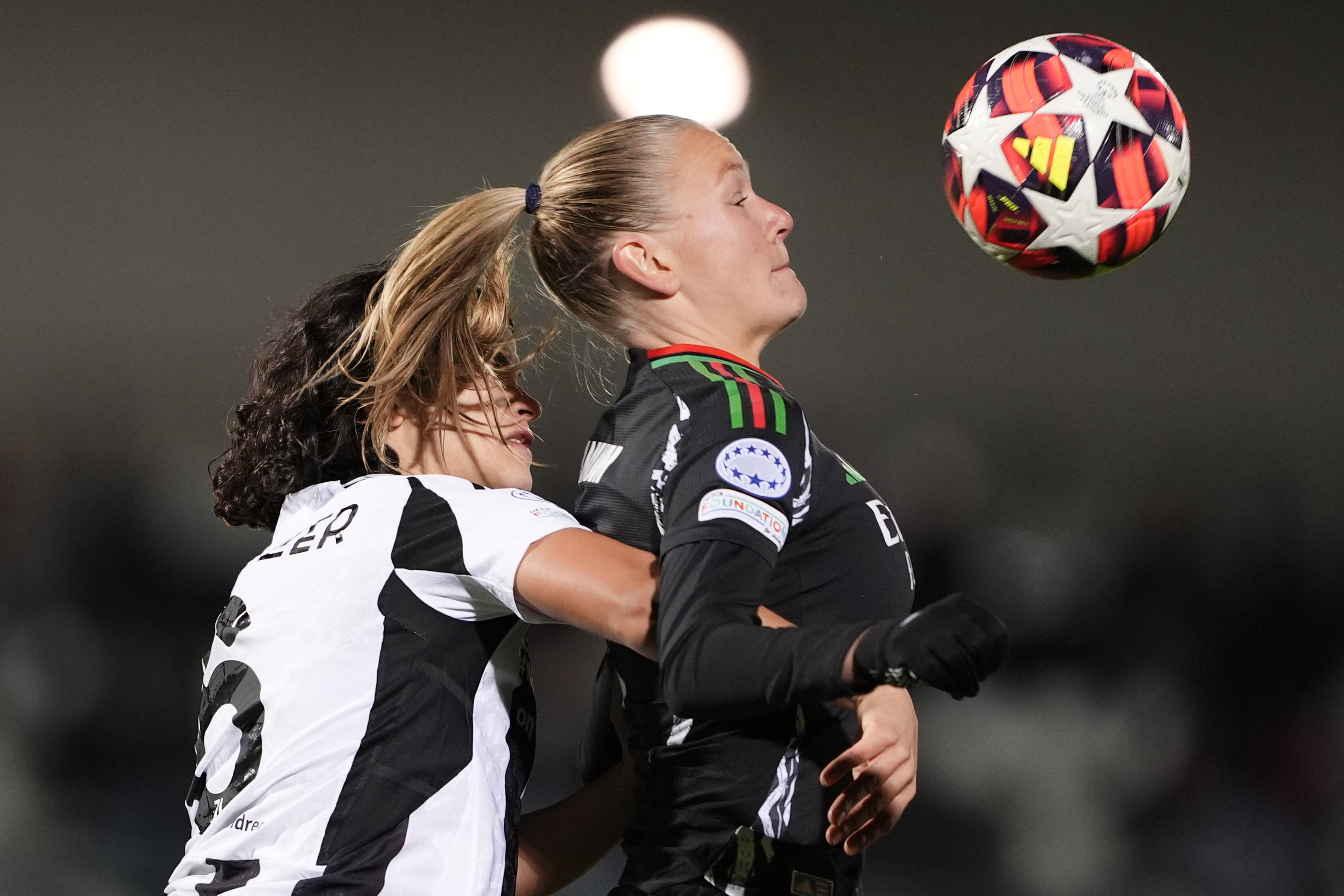 Arsenal's Frida Leonhardsen Maanum, right, and Juventus' Eva Schatzer vie for the ball during the women's Champions League soccer match between Juventus and Arsenal at the Vittorio Pozzo La Marmora Stadium in Biella, Italy, Tuesday, Nov. 12, 2024. (Fabio Ferrari/LaPresse via AP)