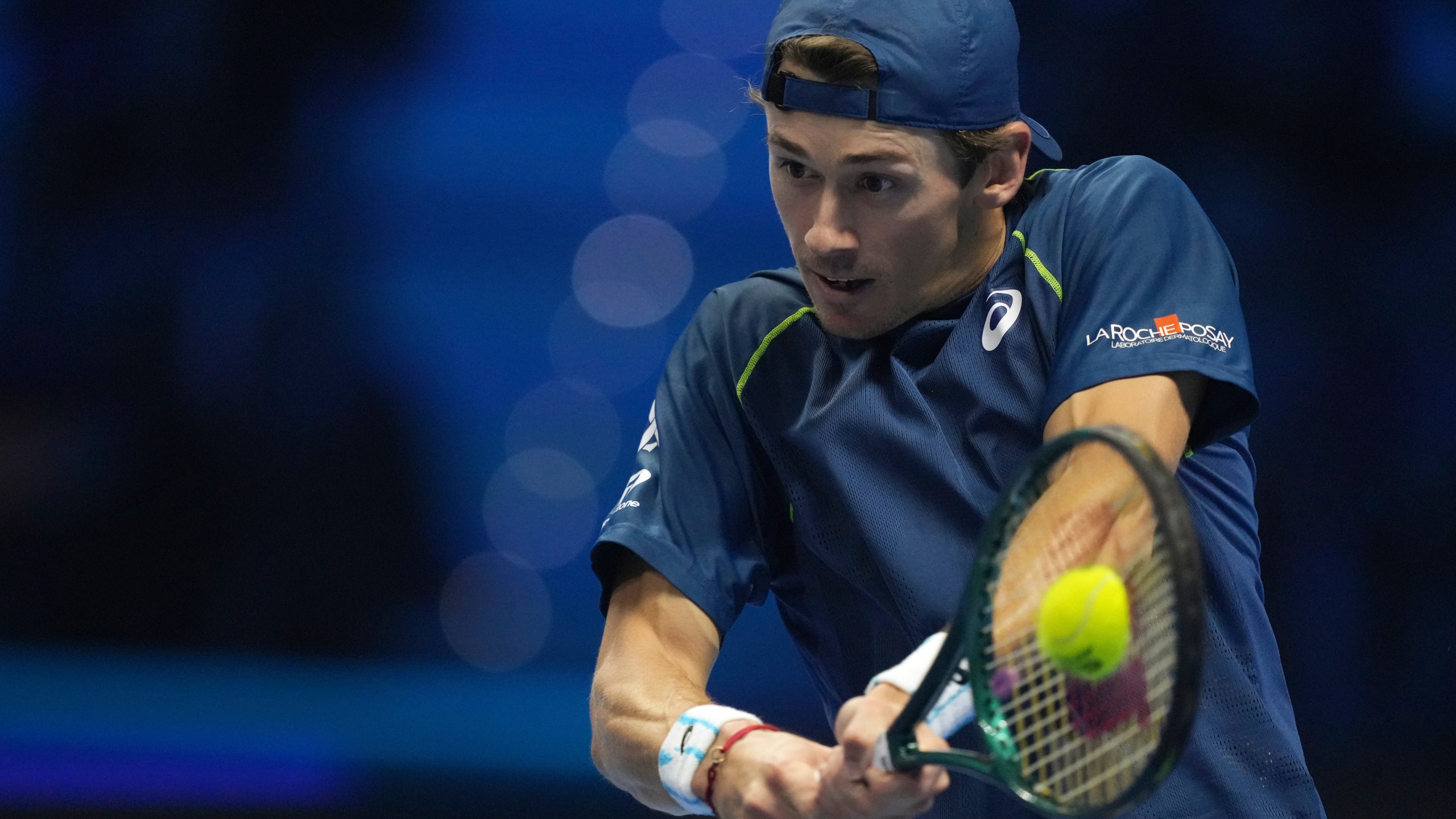 Australia's Alex de Minaur returns the ball to Russia's Daniil Medvedev during their singles tennis match of the ATP World Tour Finals at the Inalpi Arena, in Turin, Italy, Tuesday, Nov. 12, 2024. (AP Photo/Antonio Calanni)