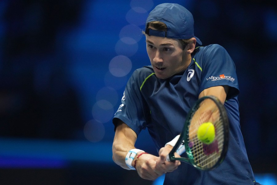 Australia's Alex de Minaur returns the ball to Russia's Daniil Medvedev during their singles tennis match of the ATP World Tour Finals at the Inalpi Arena, in Turin, Italy, Tuesday, Nov. 12, 2024. (AP Photo/Antonio Calanni)