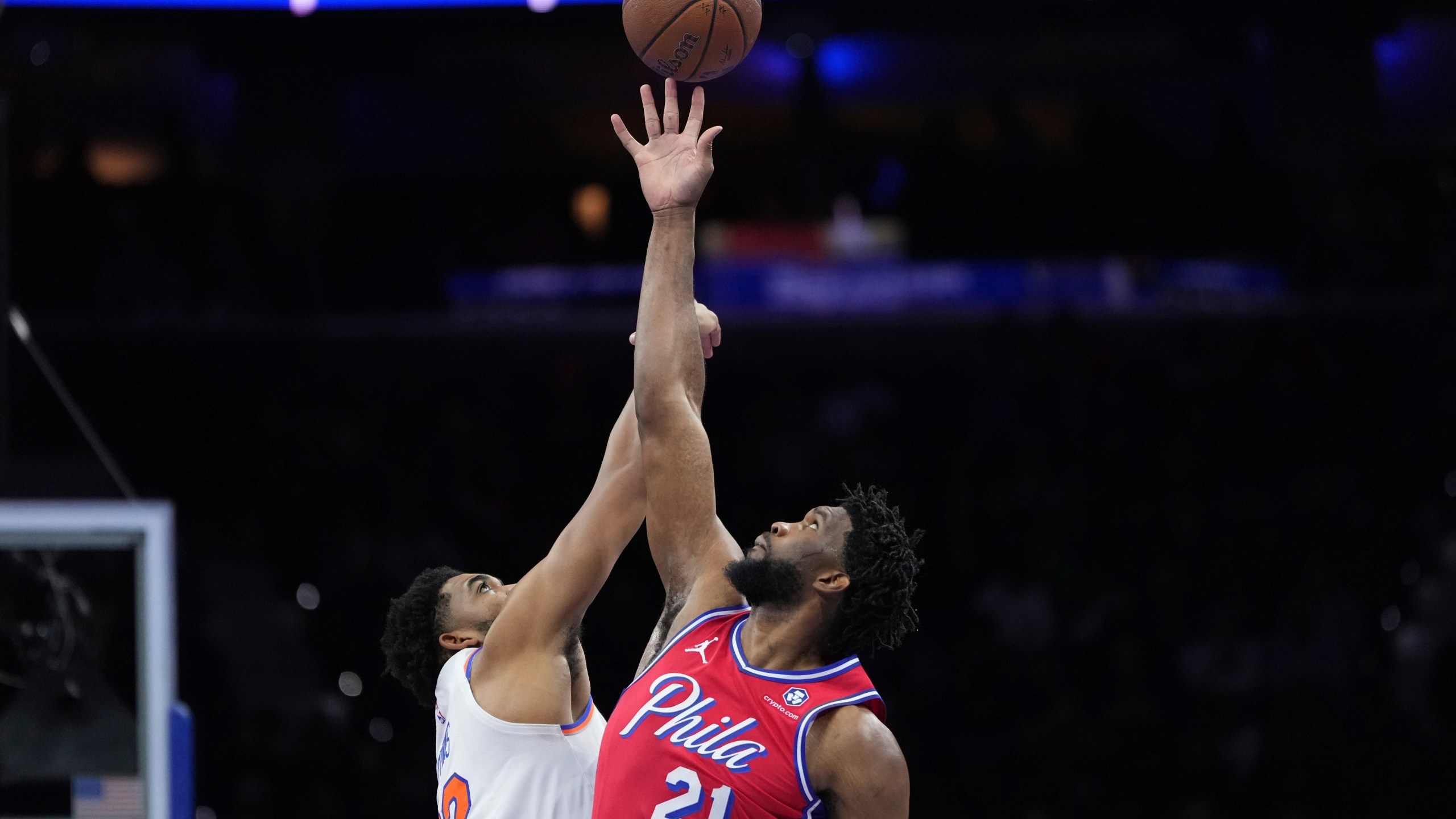 Philadelphia 76ers' Joel Embiid, right, and New York Knicks' Karl-Anthony Towns reach for the tipoff during the first half of an Emirates NBA Cup basketball game, Tuesday, Nov. 12, 2024, in Philadelphia. (AP Photo/Matt Slocum)