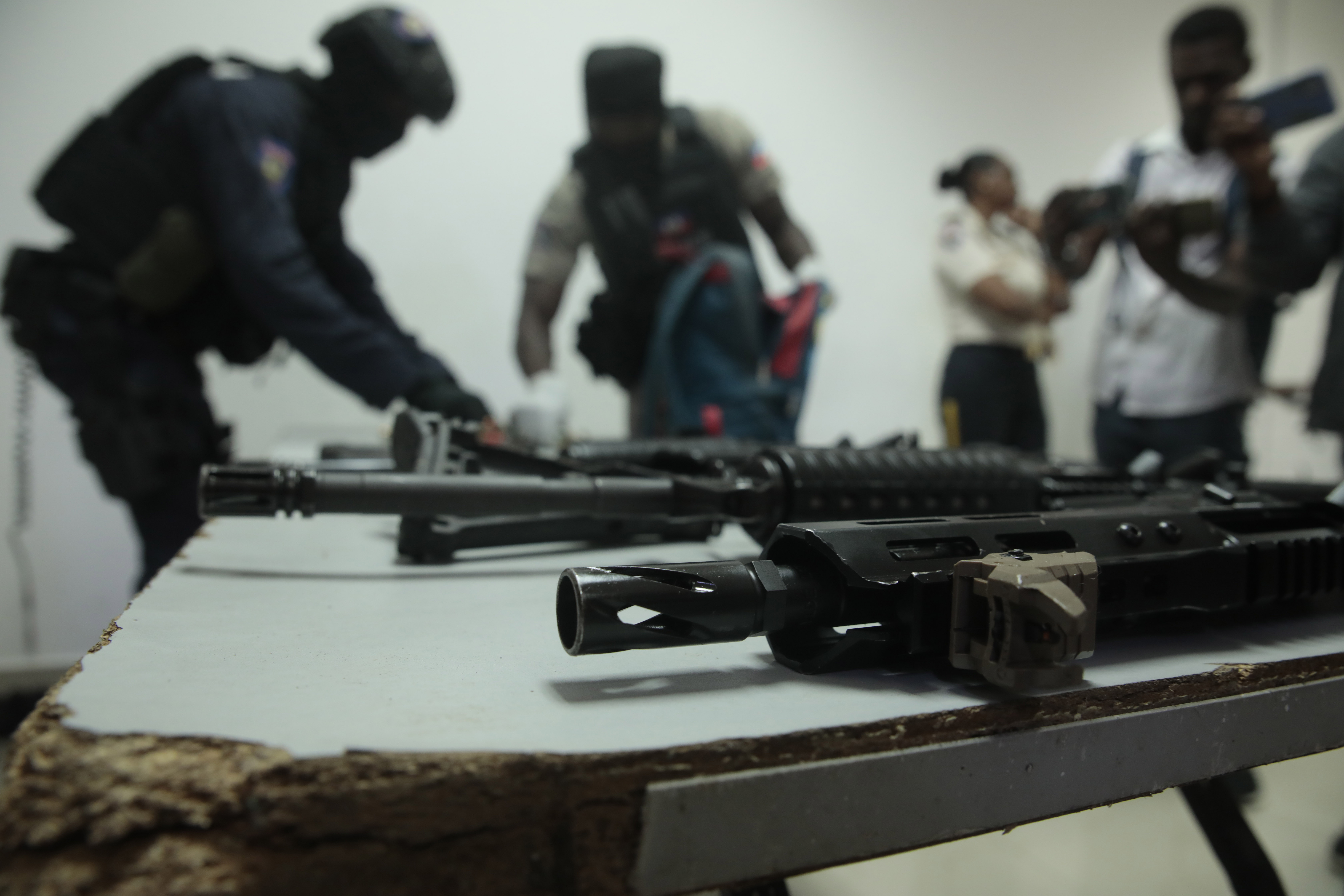 FILE - Police display weapons and equipment seized from gangs during a press conference at police headquarters in Port-au-Prince, Haiti, April 26, 2023. (AP Photo/Odelyn Joseph, File)