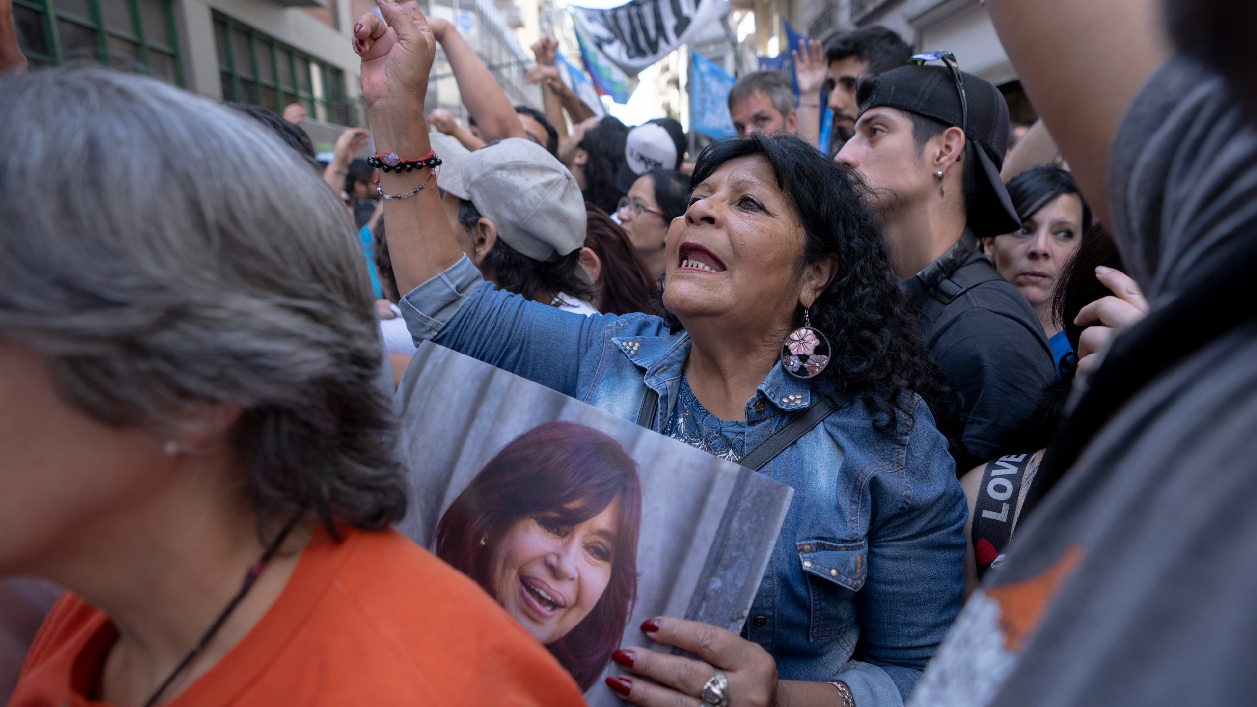 Supporters of former President Cristina Fernández rally outside her residence after a tribunal upheld a six-year sentence term and lifetime ban from holding public office sentence against Fernández, in Buenos Aires, Argentina, Wednesday, Nov. 13, 2024. (AP Photo/Victor R. Caivano)