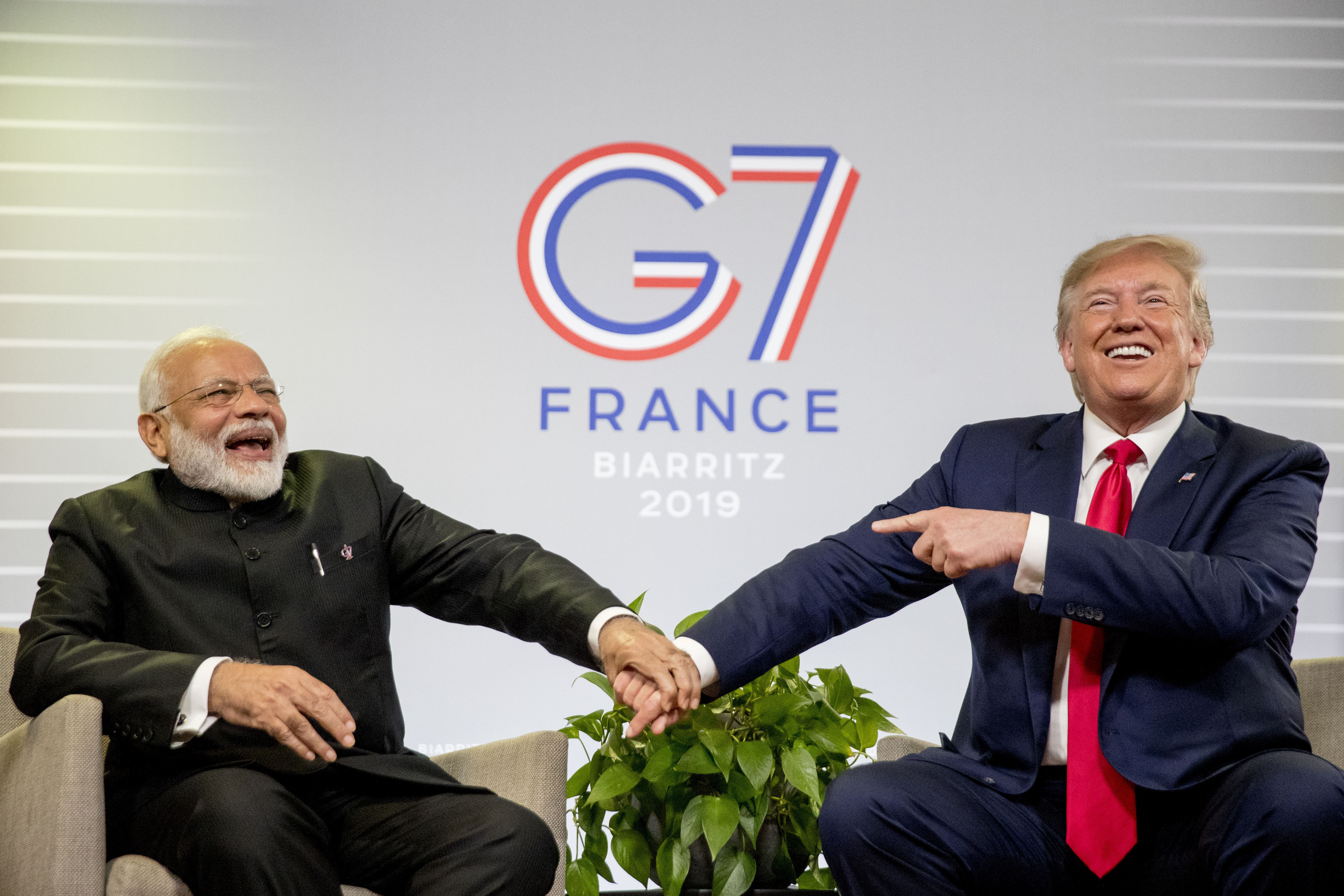 FILE- President Donald Trump and Indian Prime Minister Narendra Modi, left, share a laugh together during a bilateral meeting at the G-7 summit in Biarritz, France, Aug. 26, 2019. (AP Photo/Andrew Harnik, File)