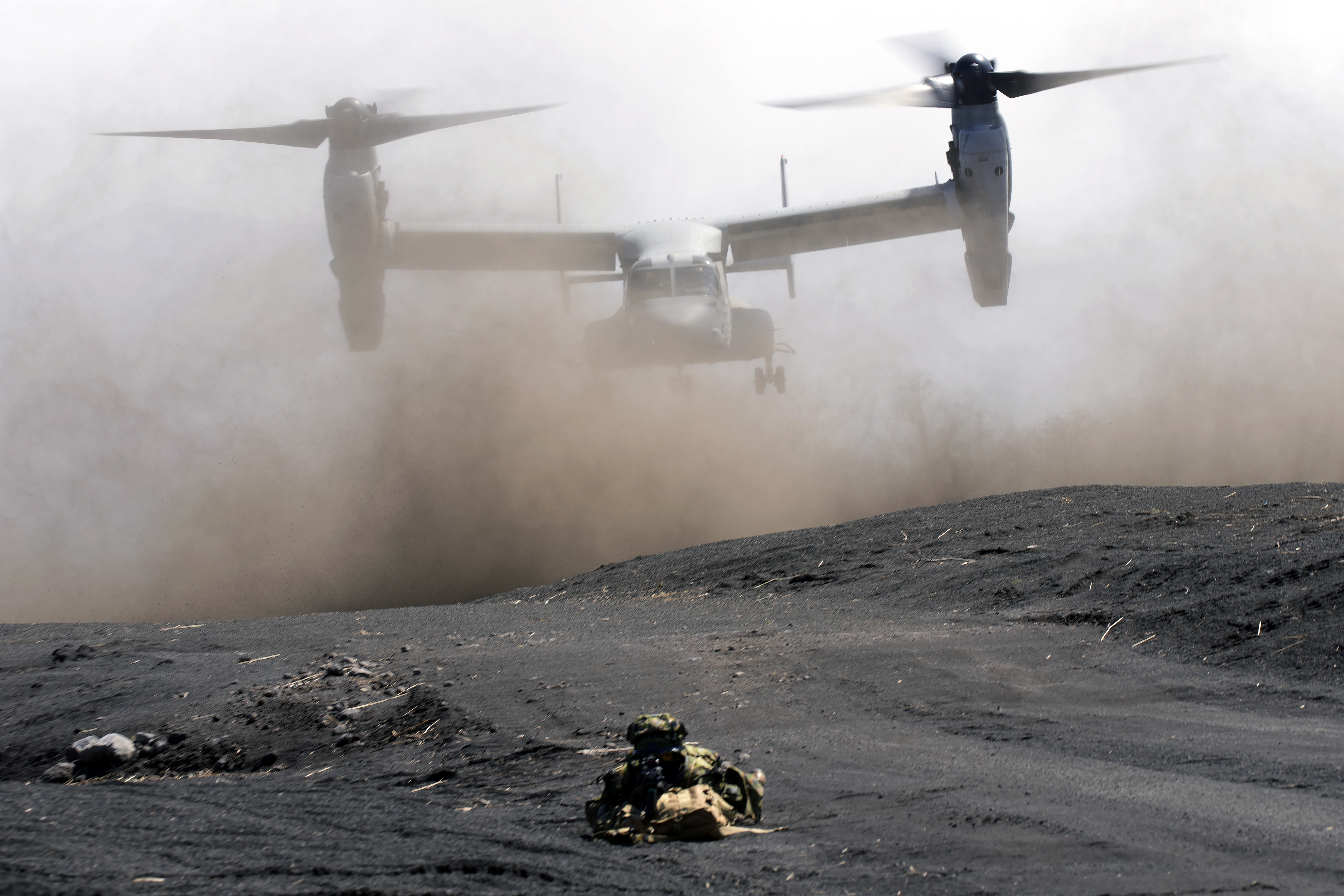 FILE - An MV-22 Osprey takes off as Japan Ground Self-Defense Force guards the landing zone during a joint military drill with U.S. Marines in Gotemba, southwest of Tokyo, March 15, 2022. (AP Photo/Eugene Hoshiko, File)