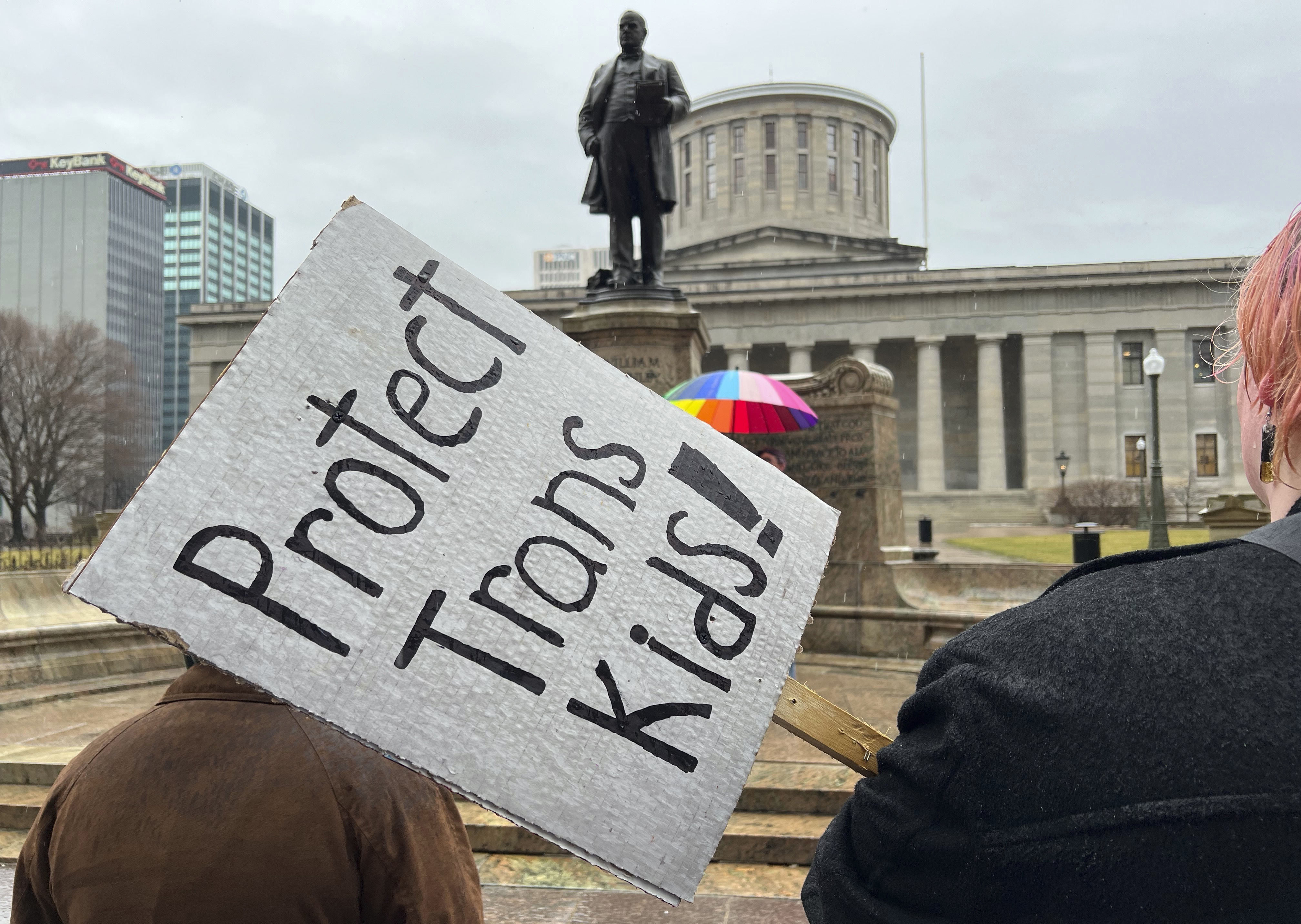 FILE - Protesters advocating for transgender rights and healthcare stand outside of the Ohio Statehouse, Jan. 24, 2024, in Columbus, Ohio. (AP Photo/Patrick Orsagost, File)