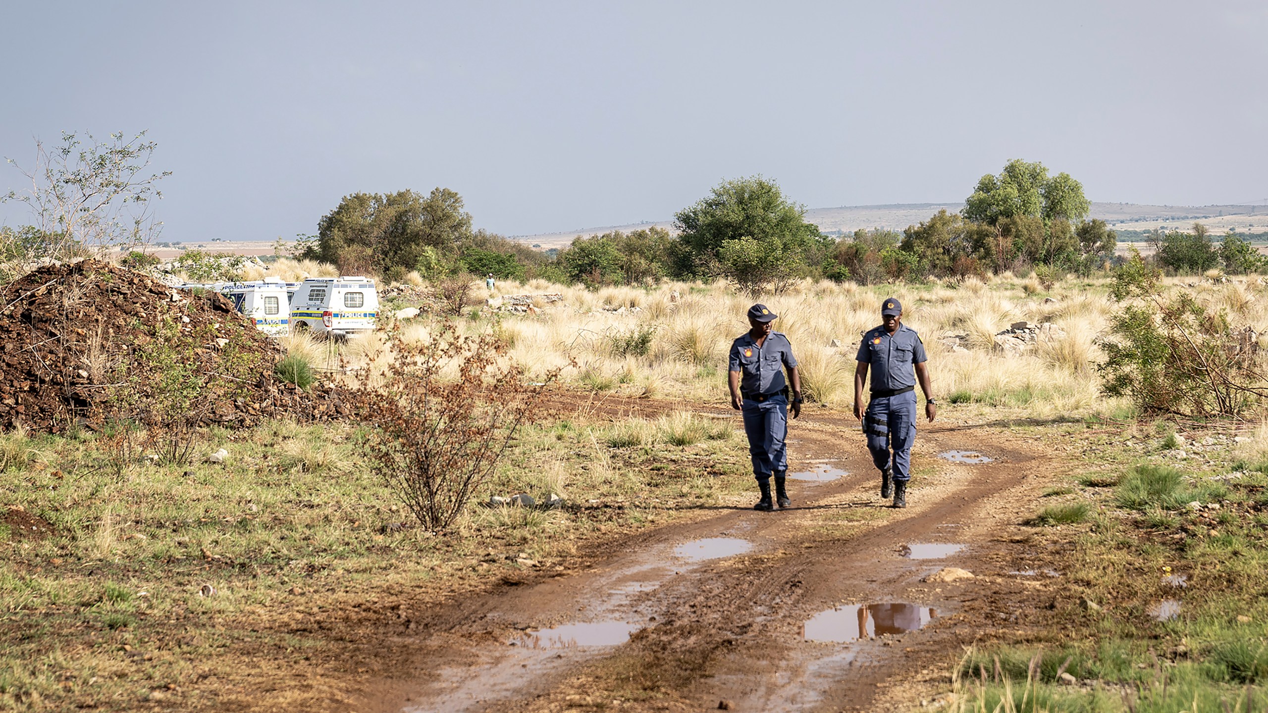 Police patrol at a mine shaft where an estimated 4000 illegal miners are trapped in a disused mine in Stilfontein, South Africa, Wednesday, Nov.13, 2024. (AP Photo)