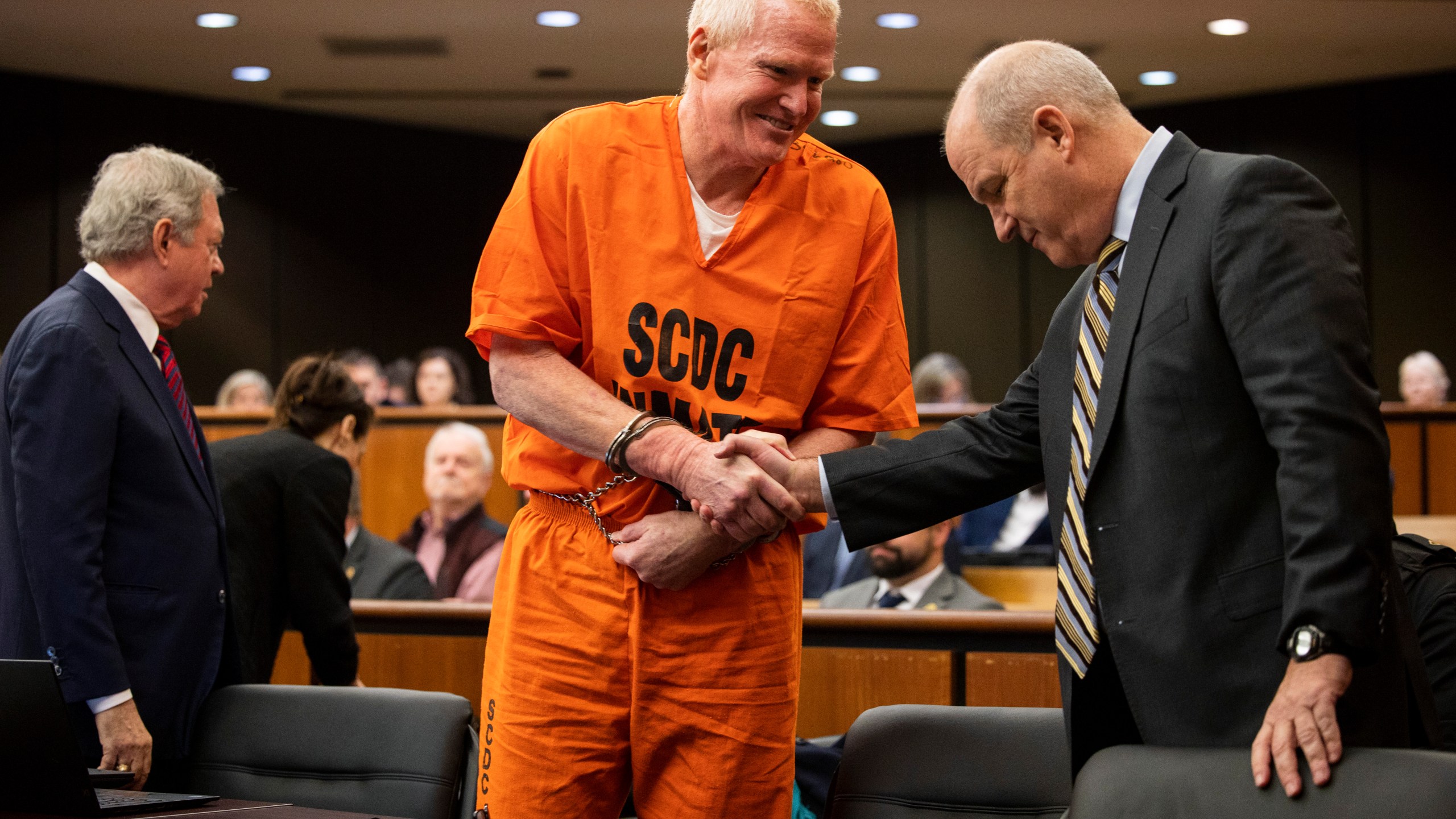 FILE- Alex Murdaugh, convicted of killing his wife, Maggie, and younger son, Paul, in June 2021, greets his defense attorney Jim Griffin before a hearing on the motion for a retrial, Tuesday, Jan. 16, 2024, at the Richland County Judicial Center, in Columbia, S.C. (Gavin McIntyre/The Post and Courier via AP, Pool, File)