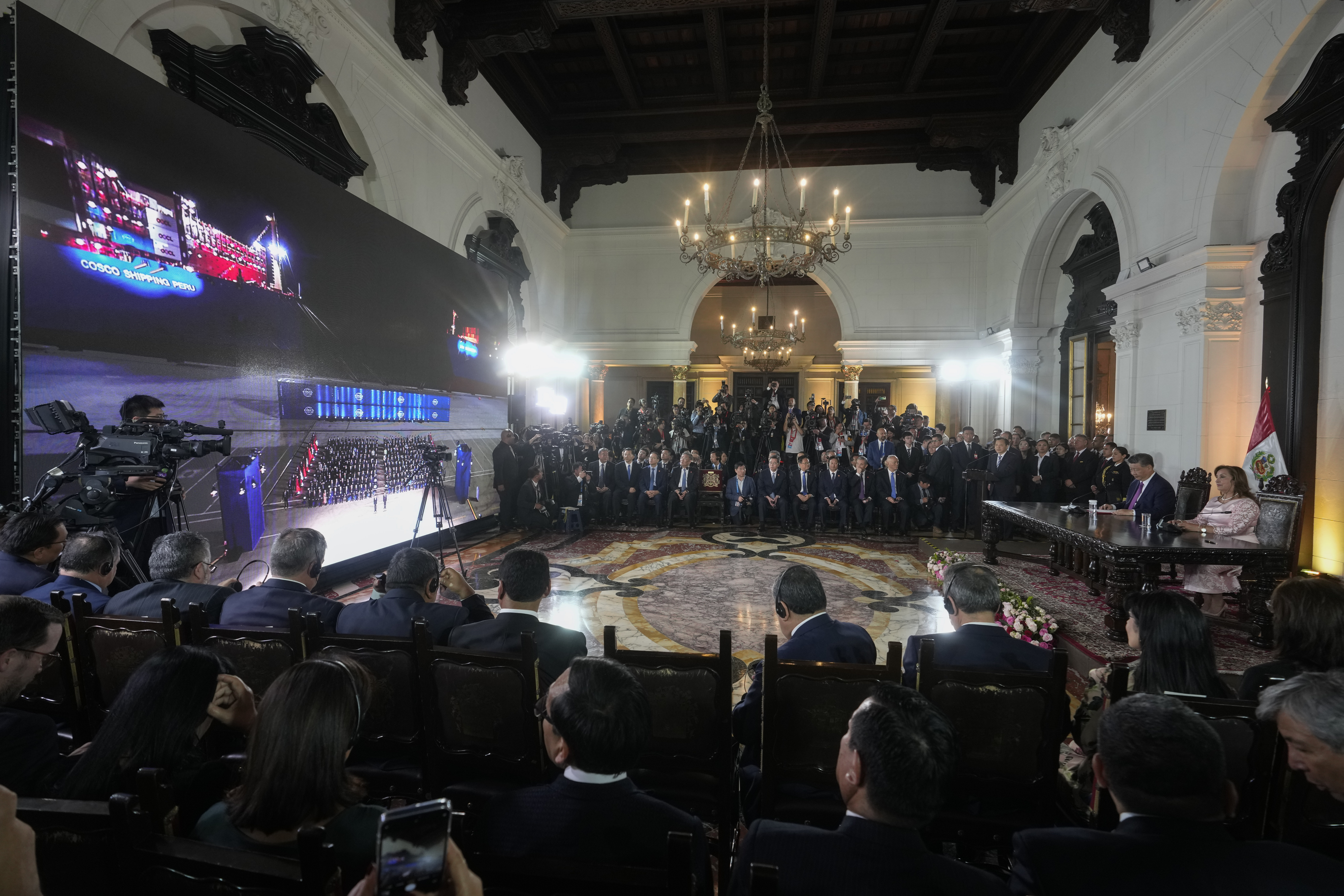 Peru's President Dina Boluarte and Chinese President Xi Jinping, both right, watch the inauguration of a Chinese-funded port in the city of Chancay, during a virtual ceremony at the government palace in Lima, Peru, Thursday, Nov. 14, 2024. (AP Photo/Fernando Vergara)